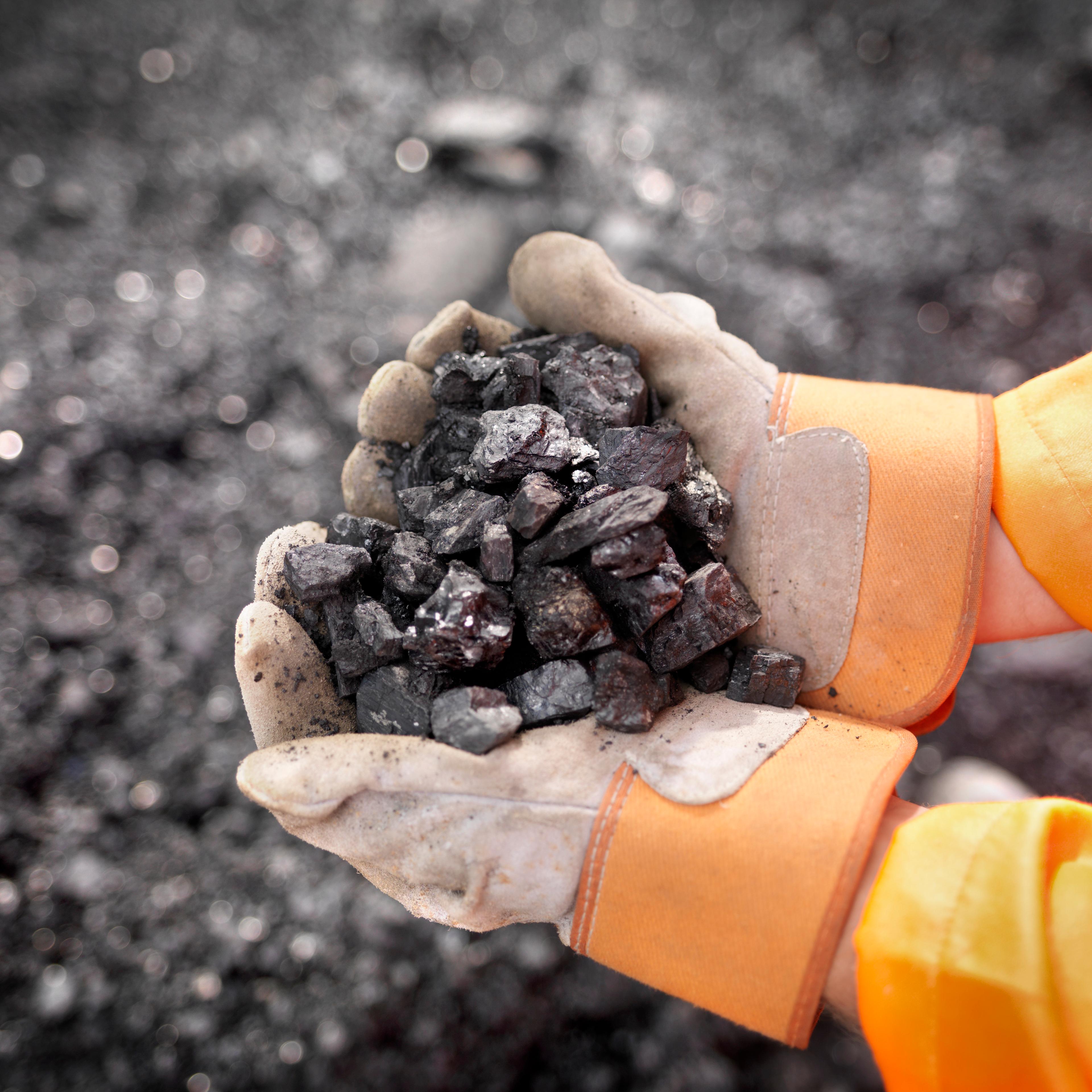 man-holding-coal
