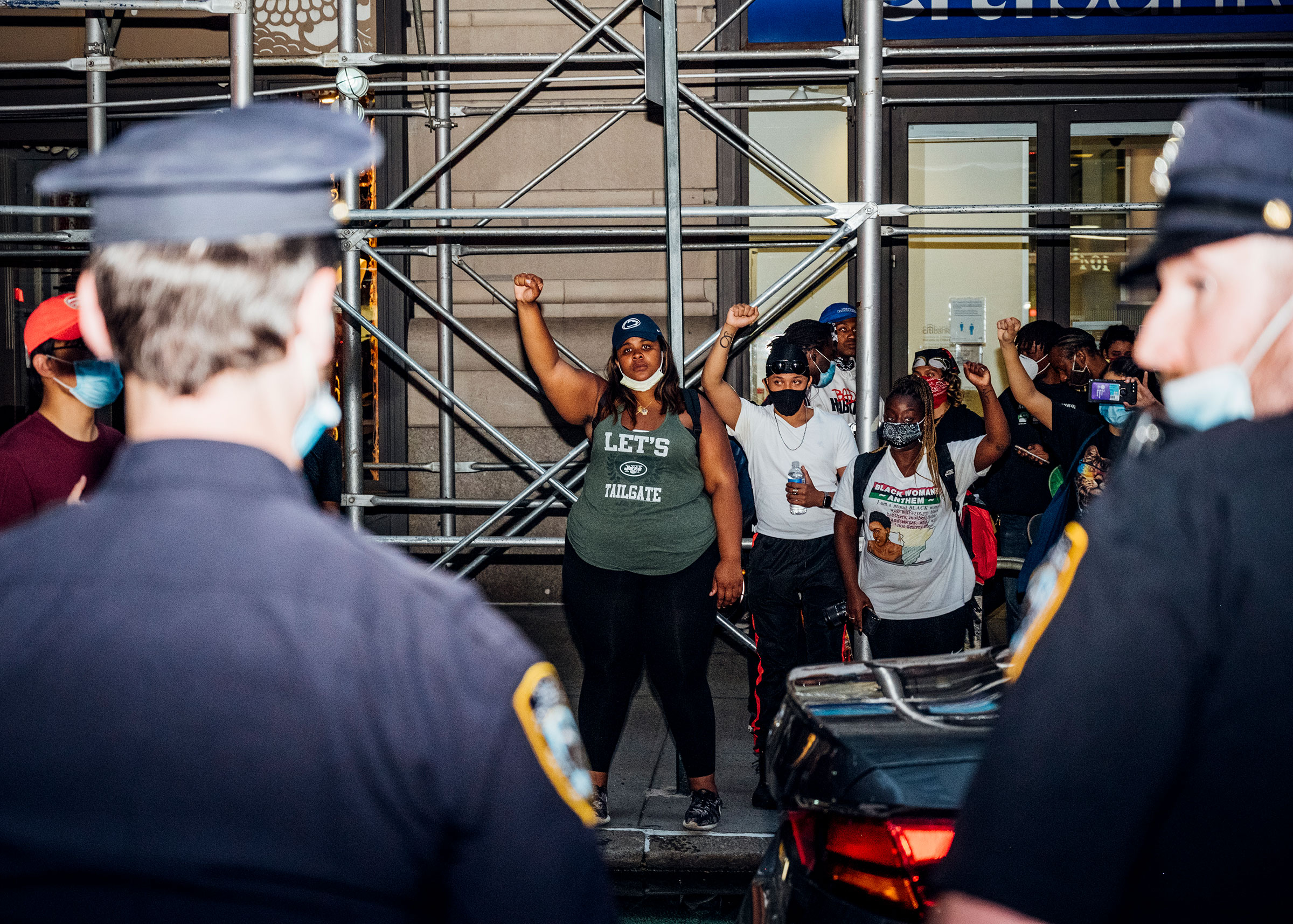 protesters face off with police officers during another night of demonstrations in Manhattan