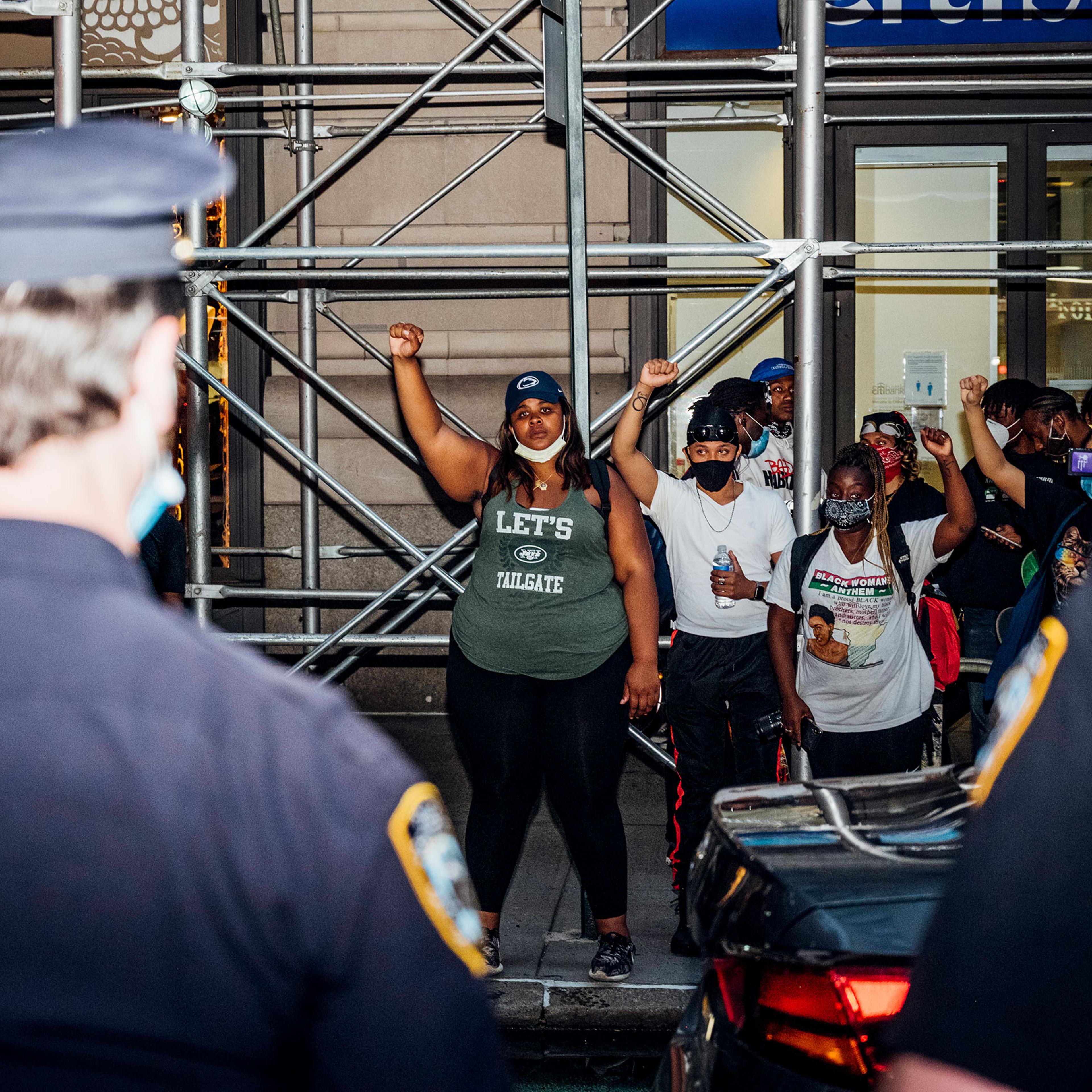 protesters face off with police officers during another night of demonstrations in Manhattan
