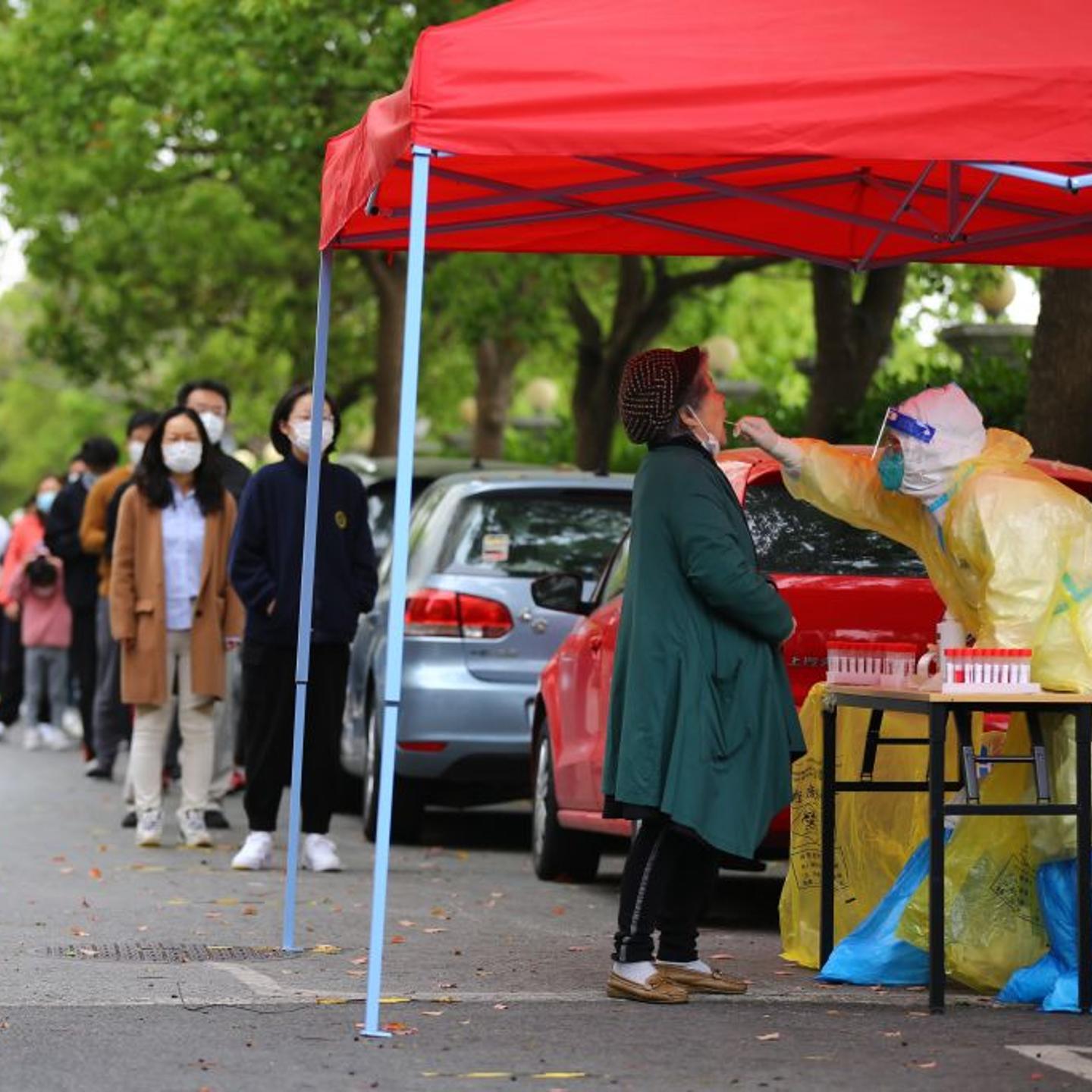Residents queue up for COVID-19 nucleic acid tests at a gated community during the phased lockdown triggered by the COVID-19 outbreak in Shanghai, China on April 19, 2022.