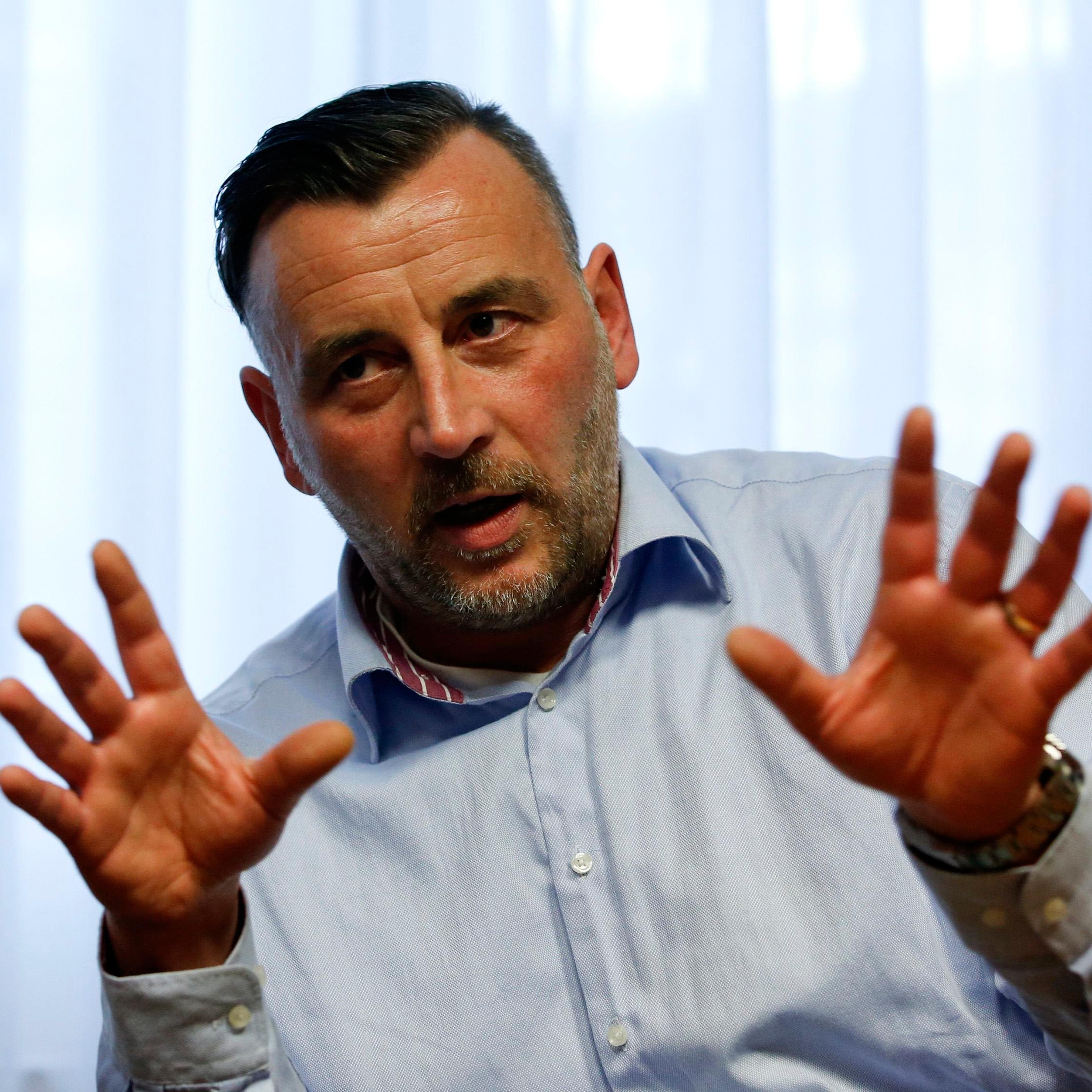 Bachmann, co-leaders of anti-immigration group PEGIDA, a German abbreviation for "Patriotic Europeans against the Islamization of the West", gestures during a Reuters interview in Dresden