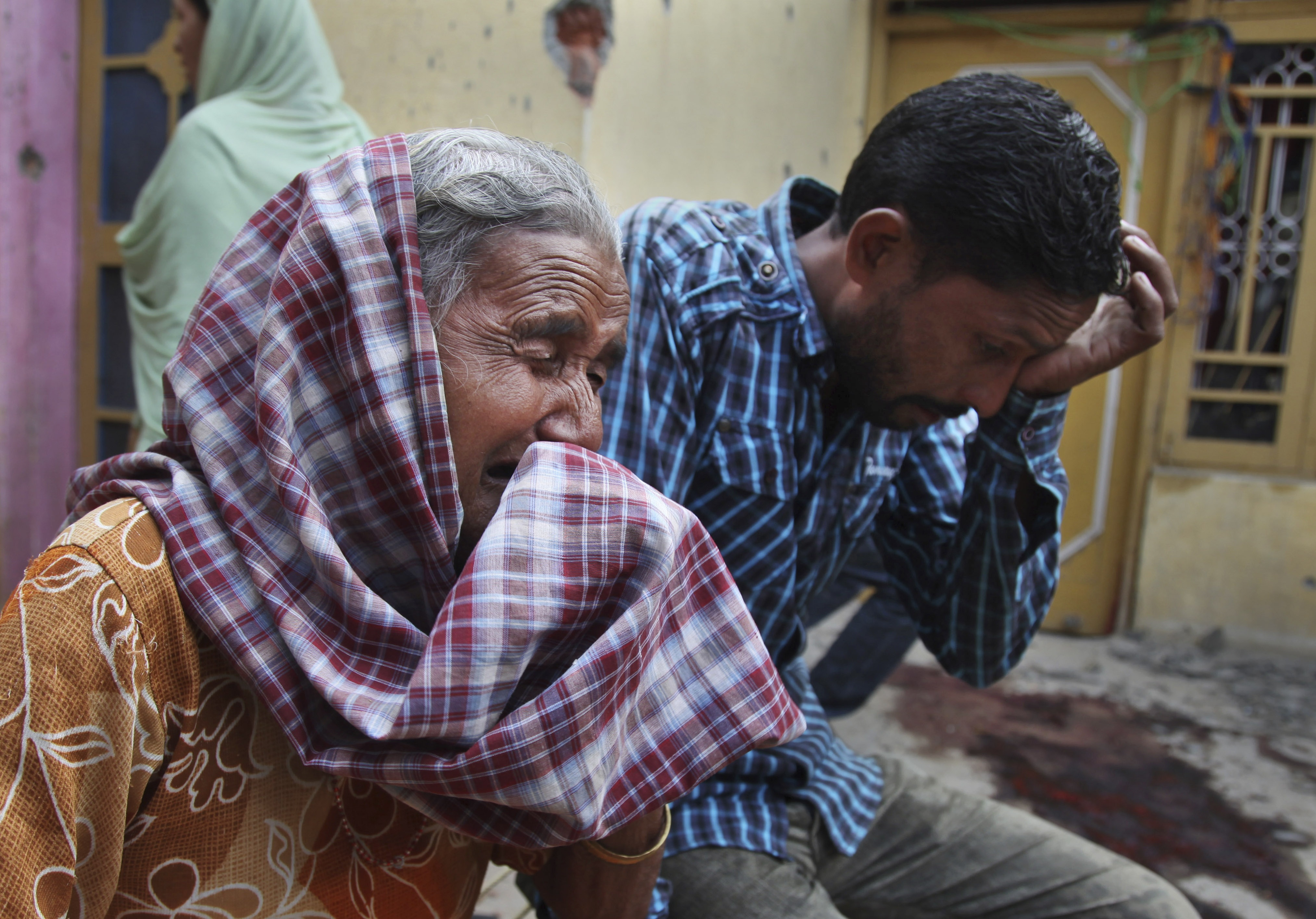 Relatives of Rajesh Kumar, who was killed in mortar shell firing allegedly from the Pakistan's side, weep inside their residential house at Masha da kothe village, in Arnia Sector near the India-Pakistan international border, about 30 miles)from Jammu, I