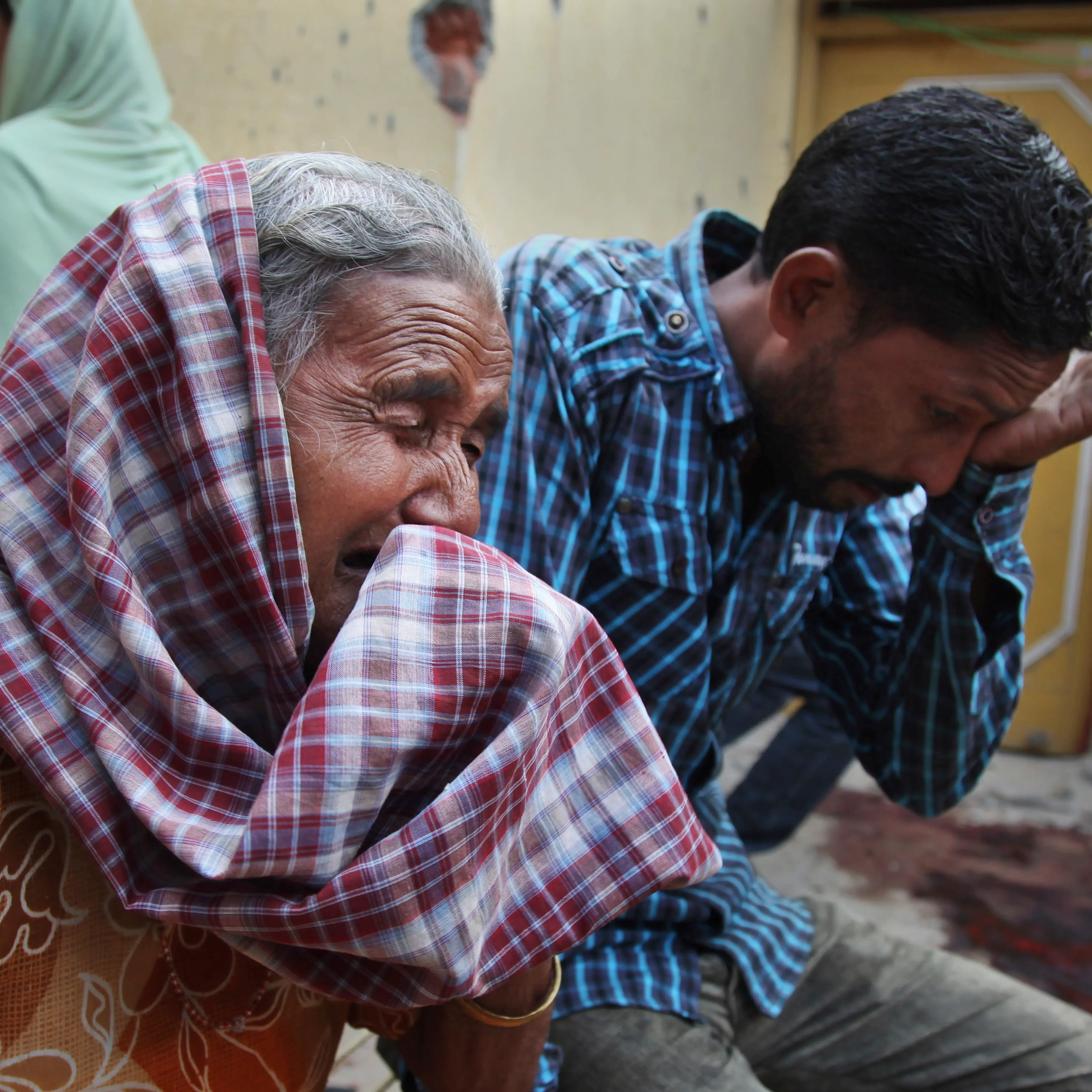 Relatives of Rajesh Kumar, who was killed in mortar shell firing allegedly from the Pakistan's side, weep inside their residential house at Masha da kothe village, in Arnia Sector near the India-Pakistan international border, about 30 miles)from Jammu, I