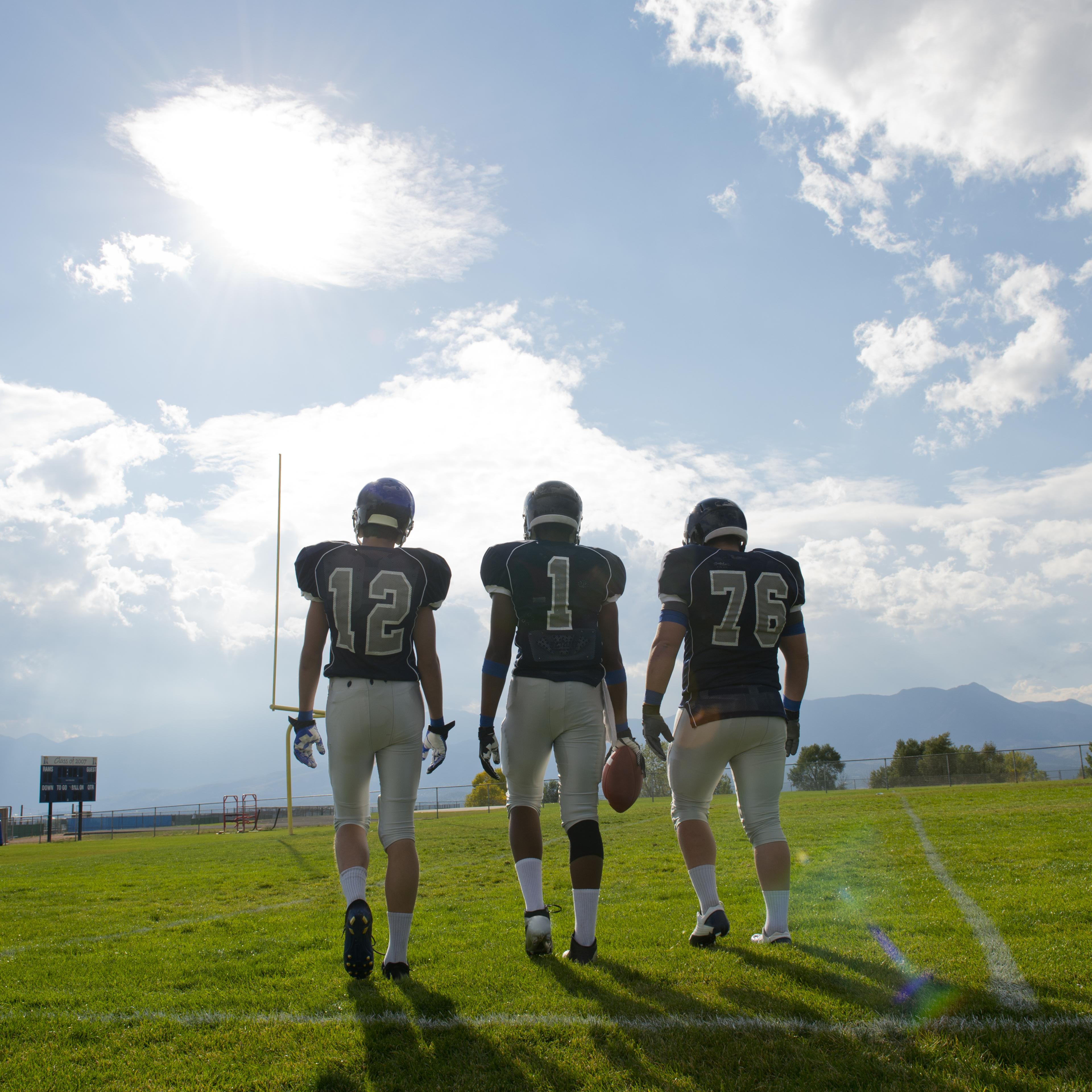 Football players walking on field