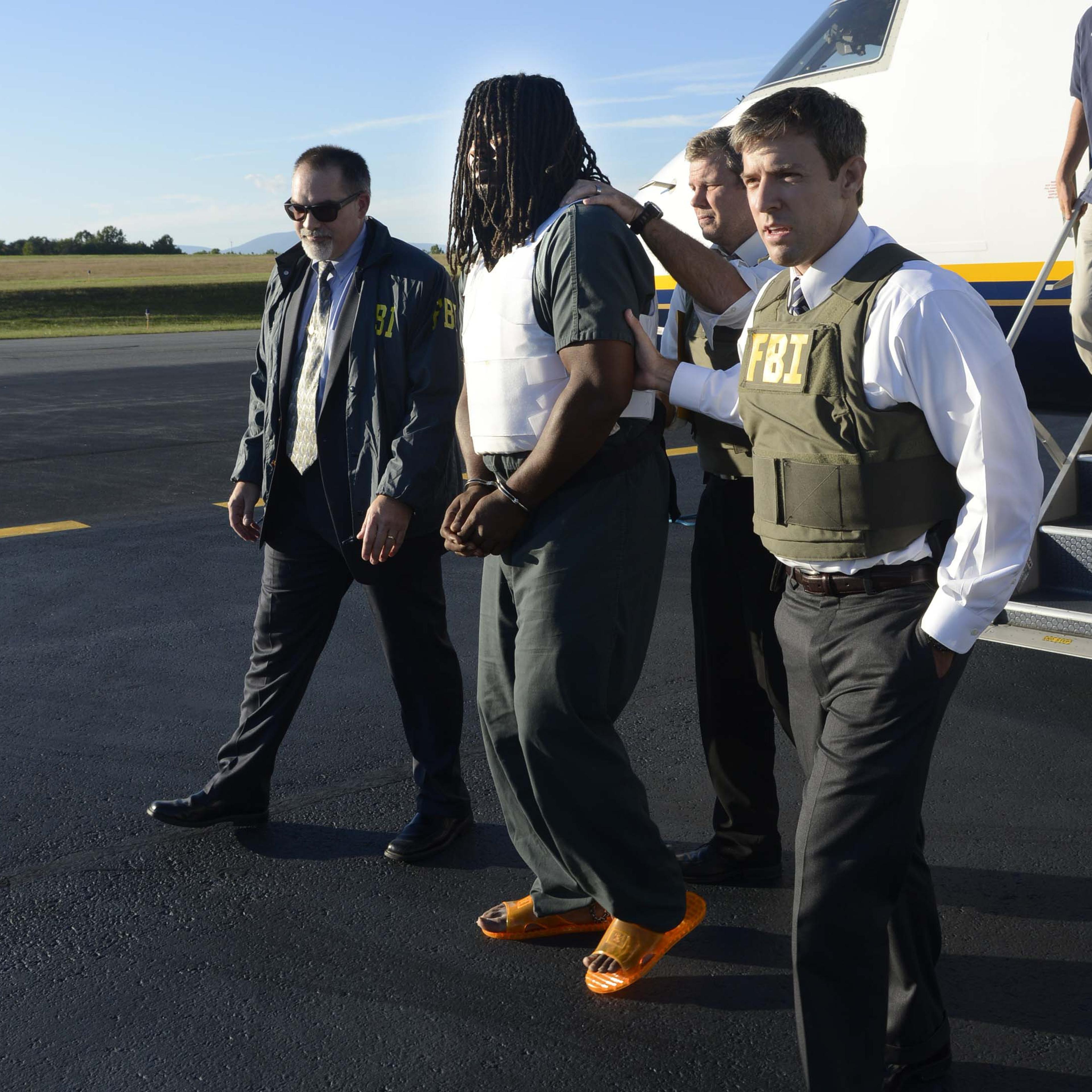 From left: FBI agents escort Jesse Matthew into the custody of the Charlottesville Police Department September 26, 2014 in Charlottesville, Virginia.