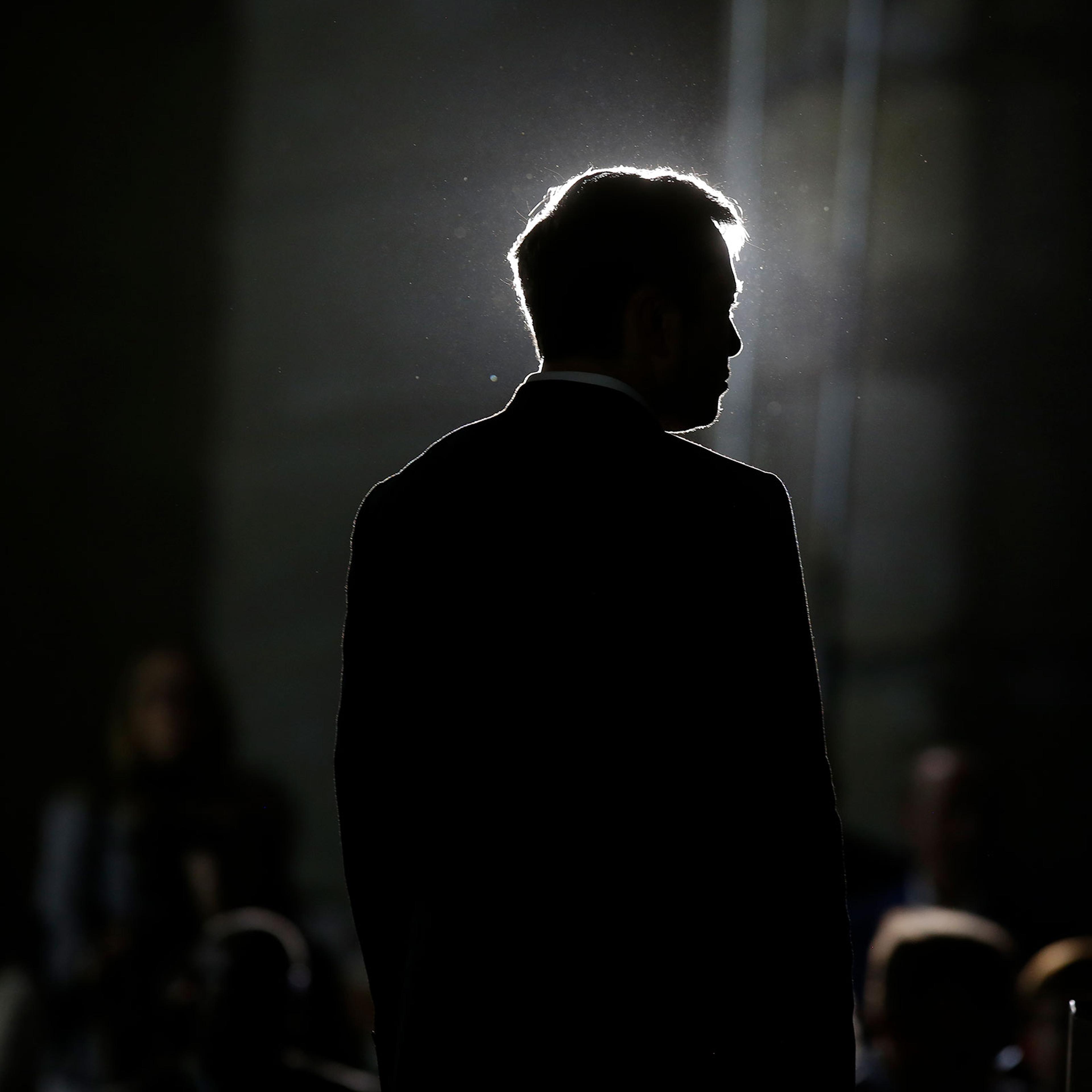 The back of Elon Musk facing a crowd