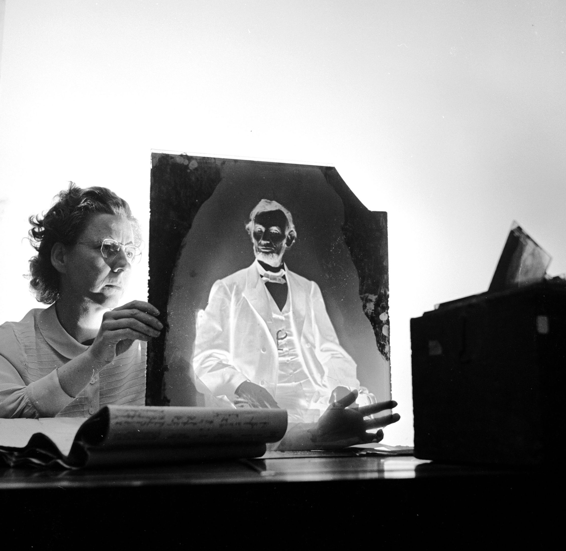A researcher holding one of America's most priceless negatives, the glass plate made by famous civil war photographer Mathew Brady of Abraham Lincoln in 1865 just before the 16th President of the United States was assassinated. It is stored in the Nation