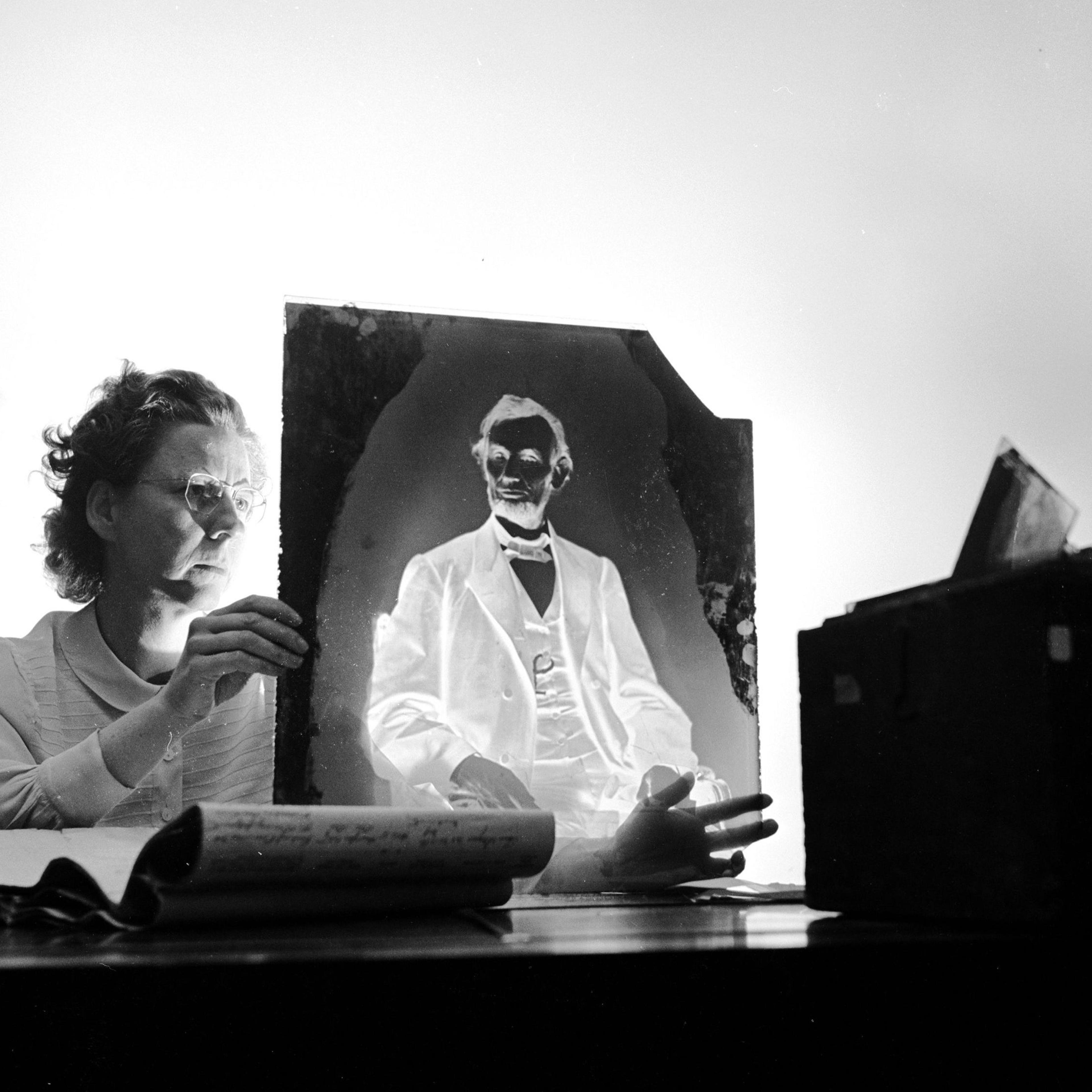 A researcher holding one of America's most priceless negatives, the glass plate made by famous civil war photographer Mathew Brady of Abraham Lincoln in 1865 just before the 16th President of the United States was assassinated. It is stored in the Nation