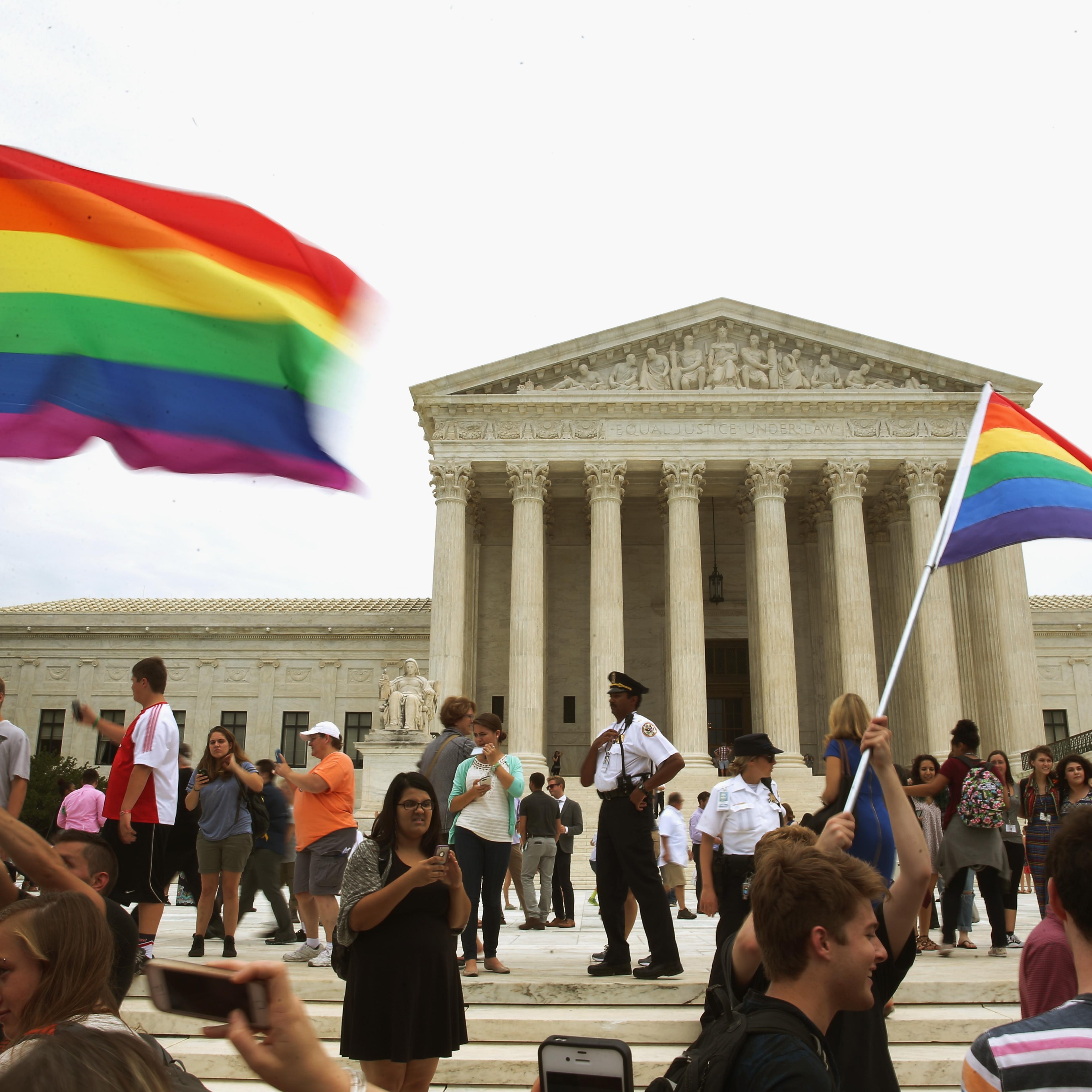 People celebrate in front of the U.S. Supreme Court after the ruling in favor of same-sex marriage June 26, 2015 in Washington, DC.