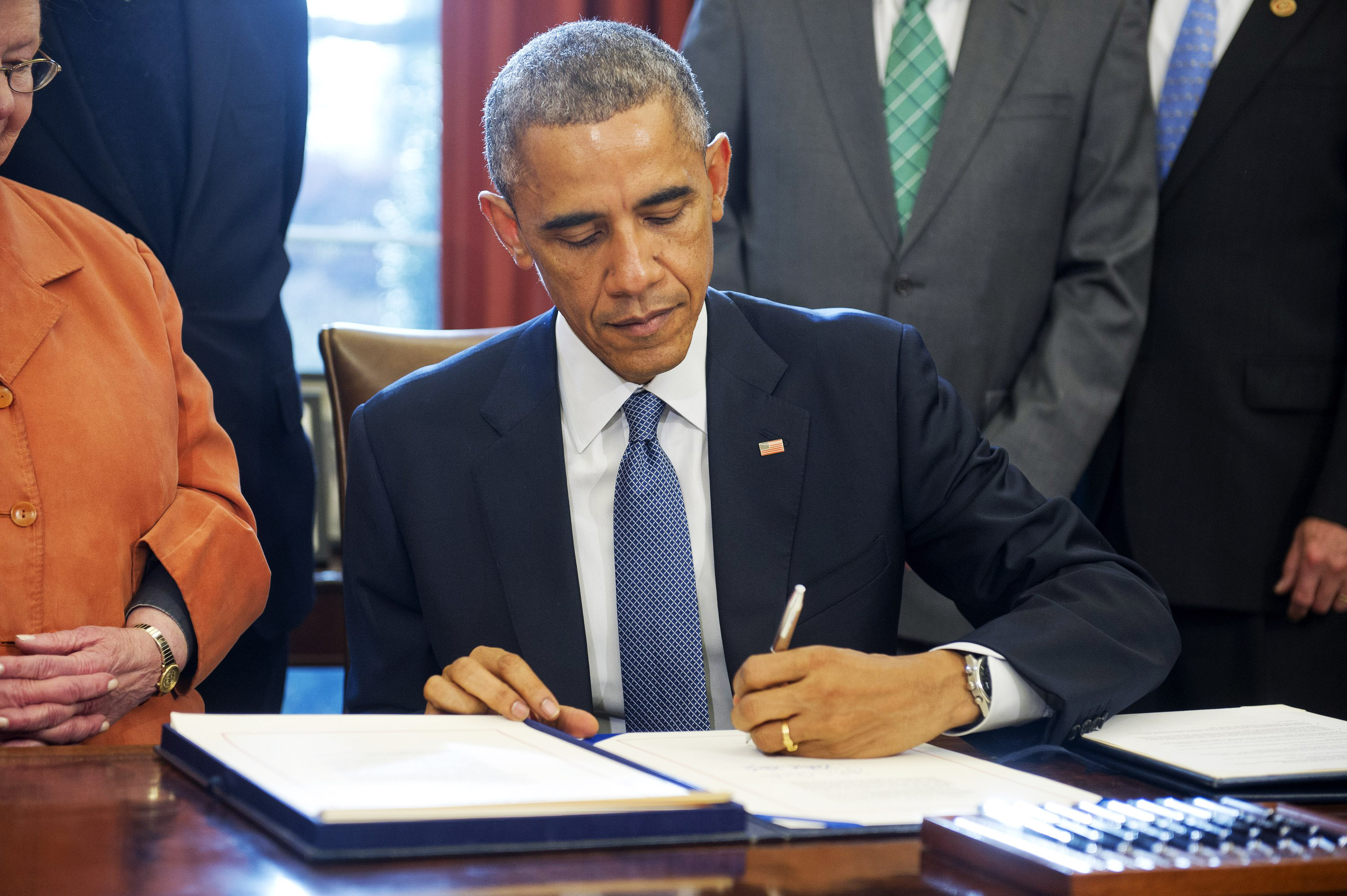 President Barack Obama signs S. 1086, the Child Care and Development Block Grant Act of 2014, into law in the Oval Office of the White House on Nov. 19, 2014 in Washington, D.C.