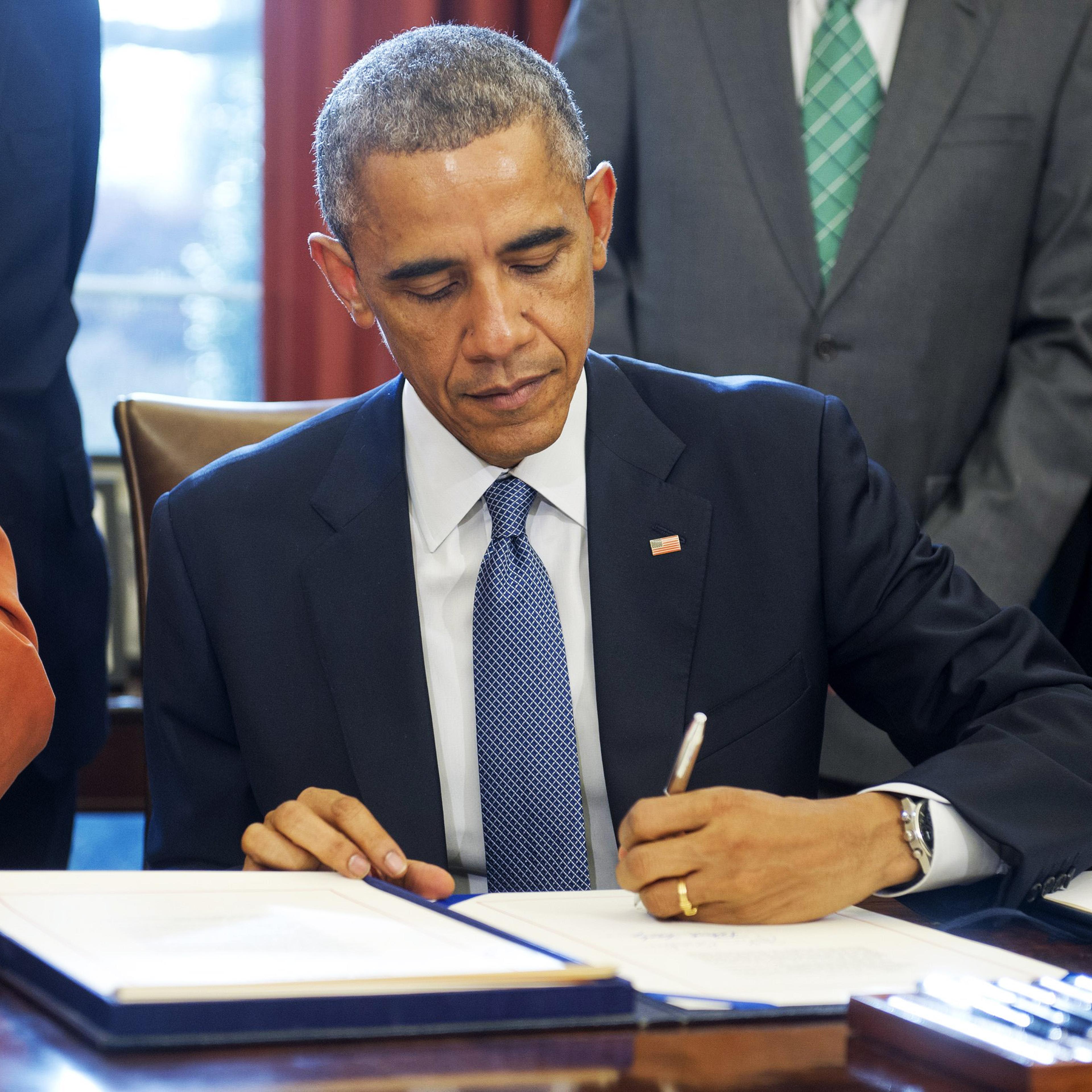 President Barack Obama signs S. 1086, the Child Care and Development Block Grant Act of 2014, into law in the Oval Office of the White House on Nov. 19, 2014 in Washington, D.C.