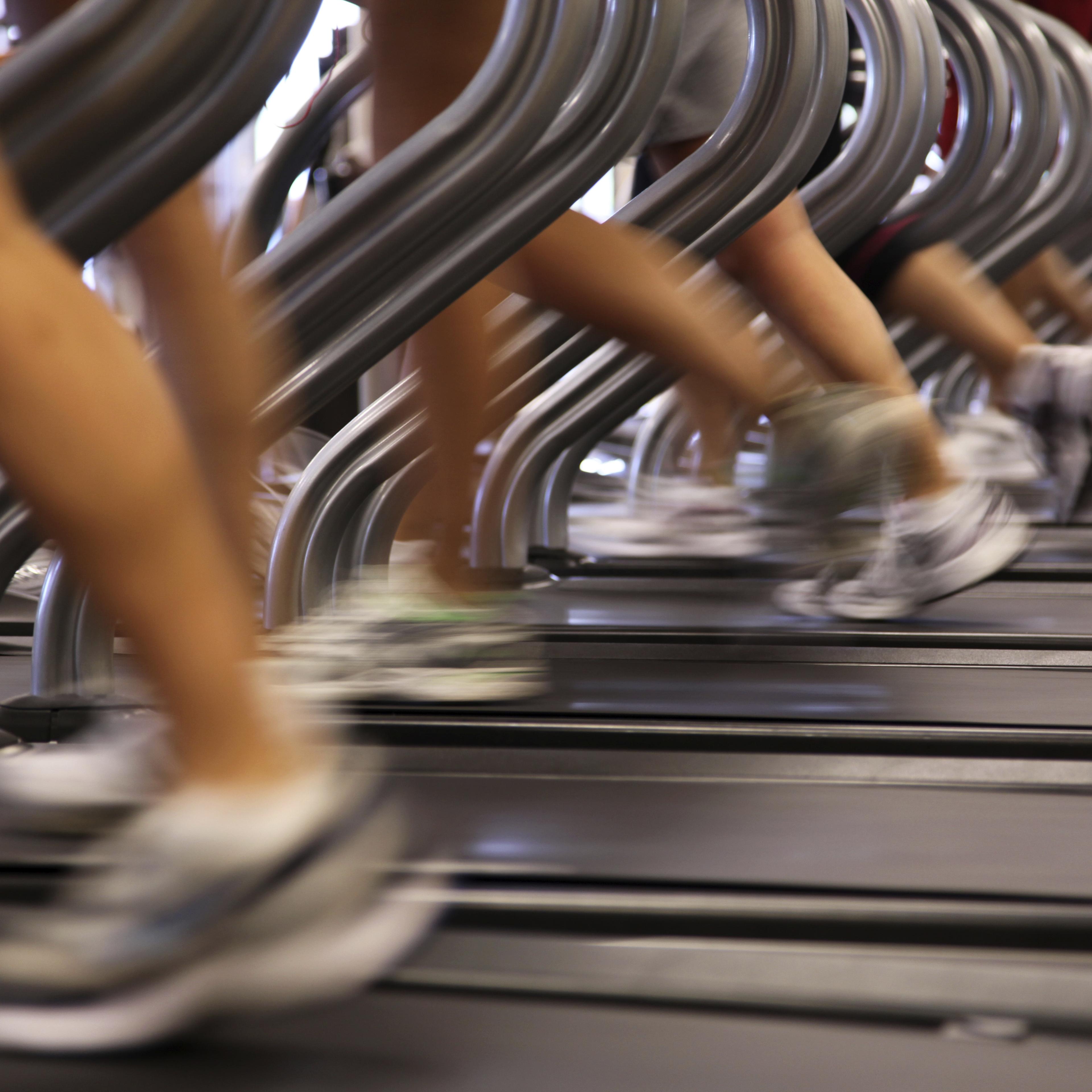 People Running Jogging on Treadmill at Health Club Gym