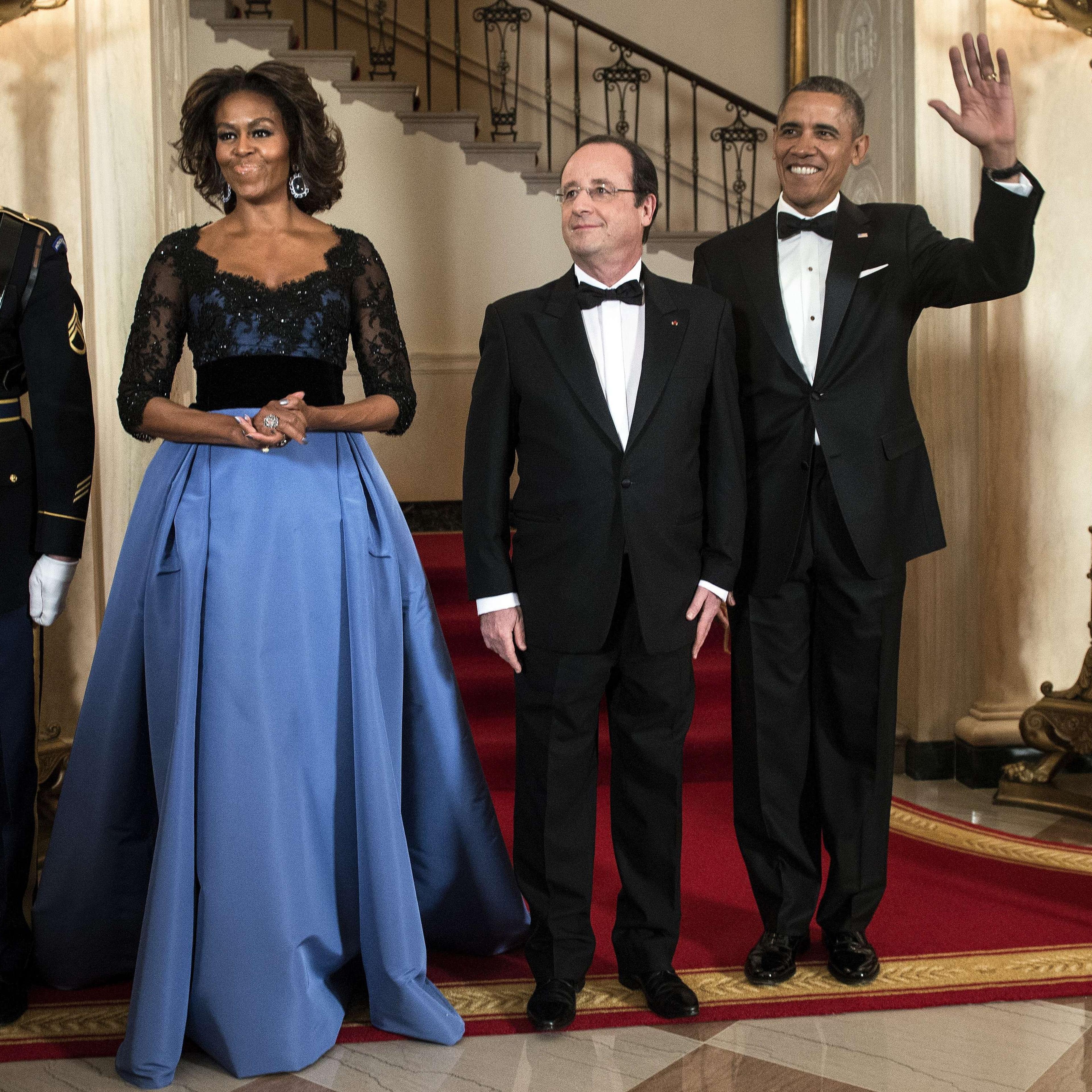 First Lady Michelle Obama, French President Francois Hollande and President Barack Obama pose in front of the Grand Staircase for an official photo before a State Dinner at the White House February 11, 2014 in Washington.