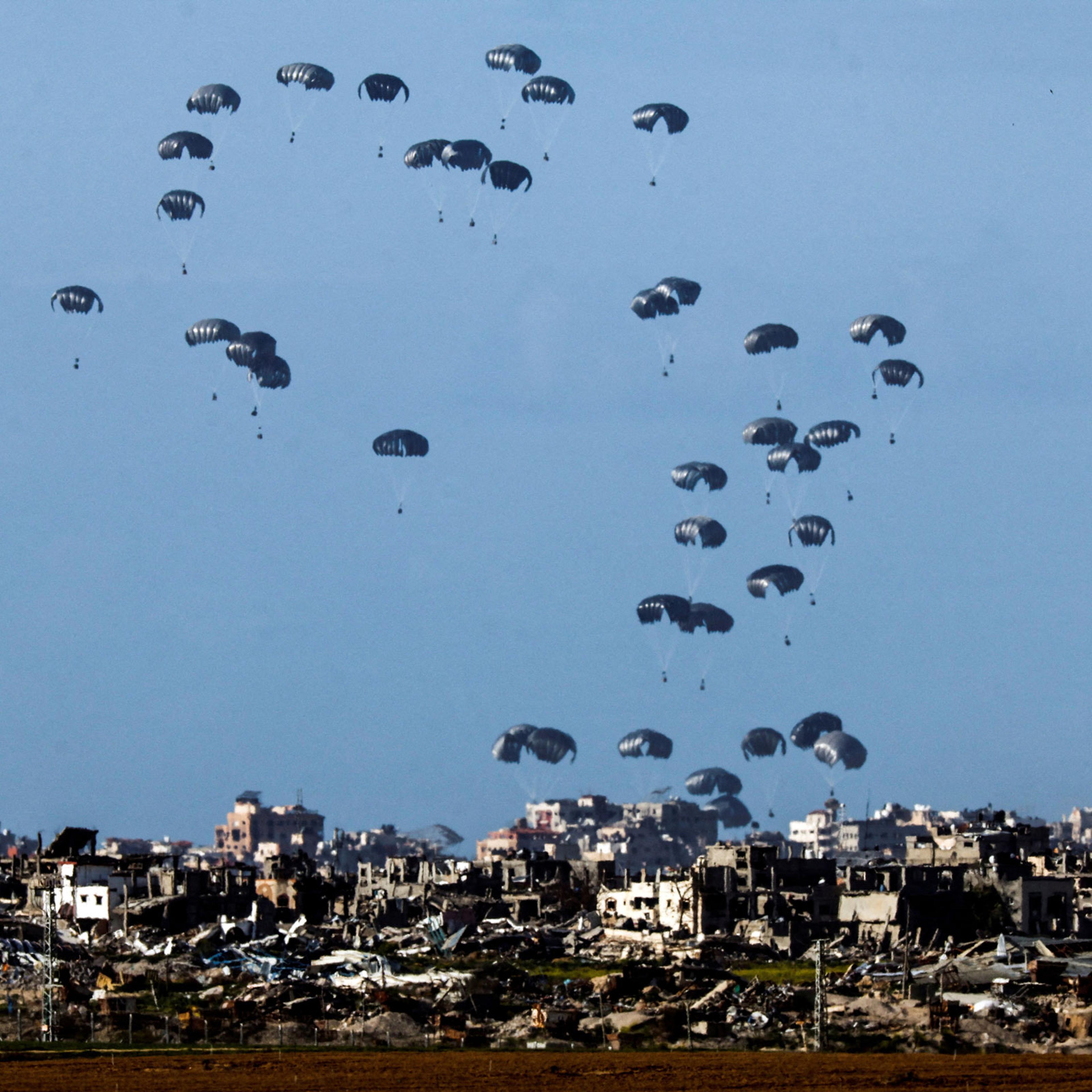 Packages fall towards northern Gaza, after being dropped from a military aircraft