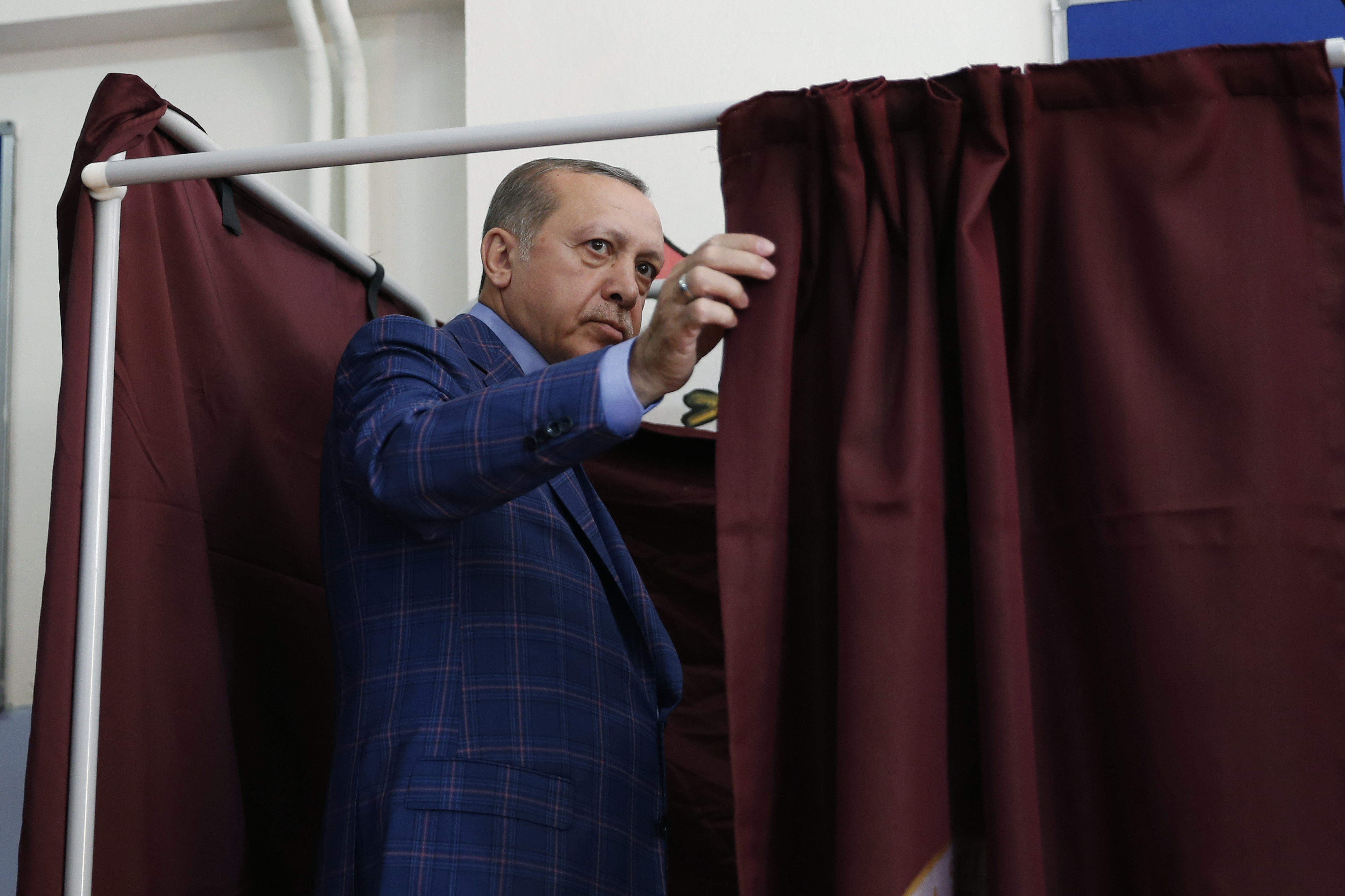 Turkey's President Recep Tayyip Erdogan enters a voting booth inside a polling station in Istanbul, April 16, 2017.
