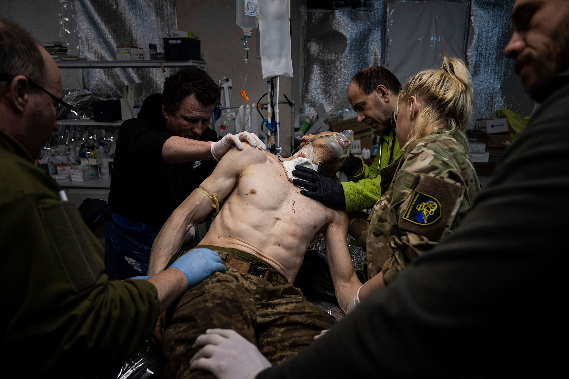 Ukrainian military medics treat their wounded comrade at the field hospital near Bakhmut, Ukraine, on Feb. 26.