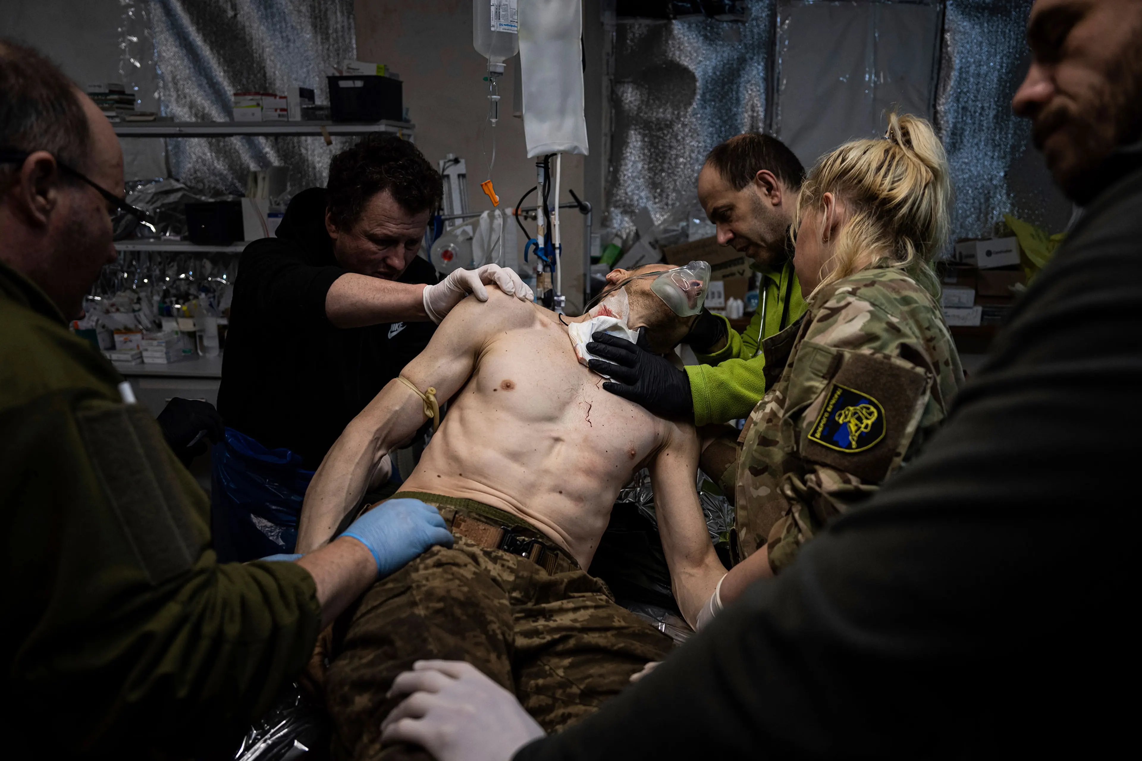 Ukrainian military medics treat their wounded comrade at the field hospital near Bakhmut, Ukraine, on Feb. 26.
