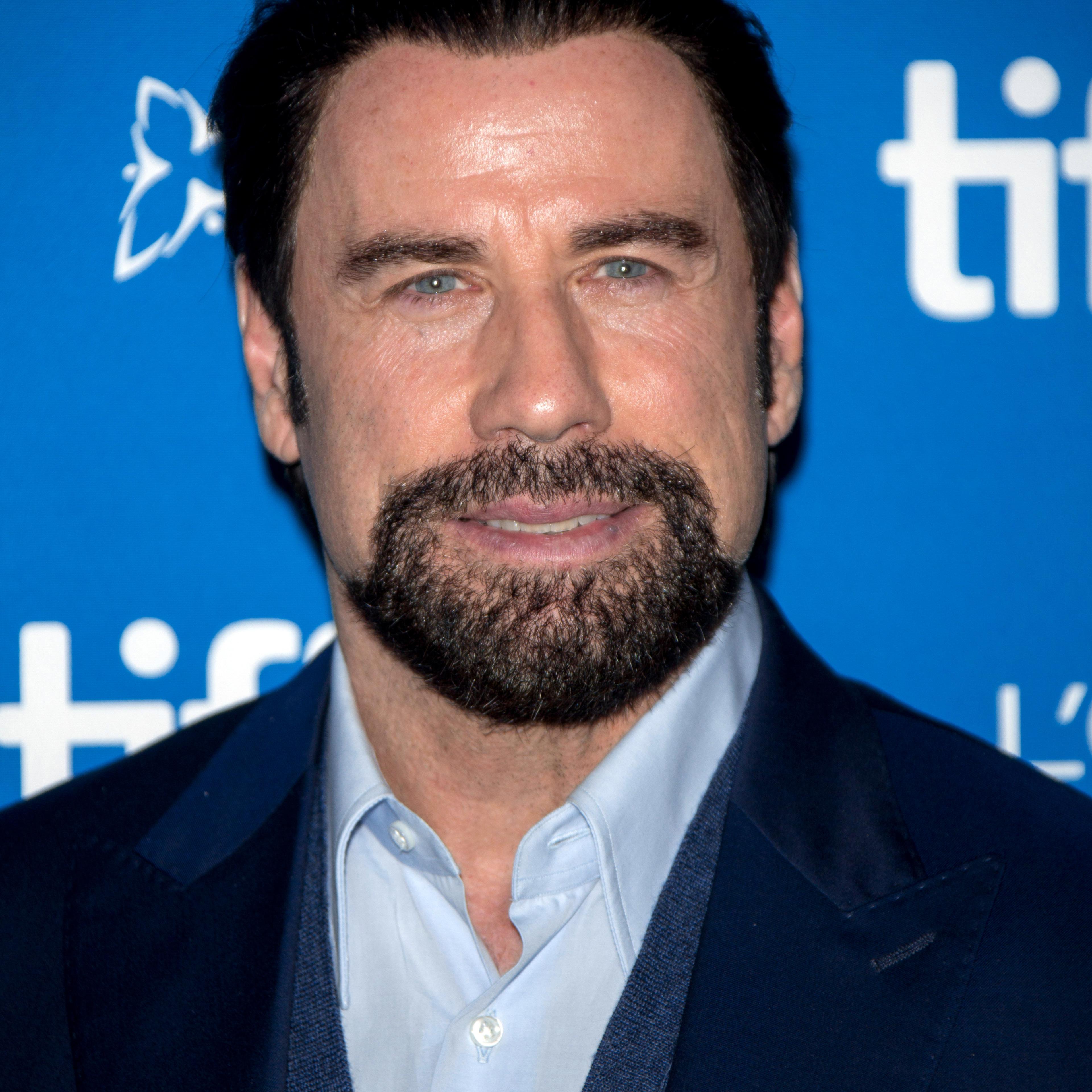 Actor John Travolta poses at the photocall of "The Forger" during the 39th Toronto International Film Festival (TIFF) in Toronto, Canada on Sept. 12, 2014.