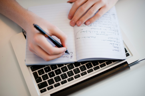 hand-writing-laptop-keyboard