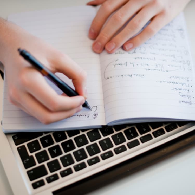 hand-writing-laptop-keyboard
