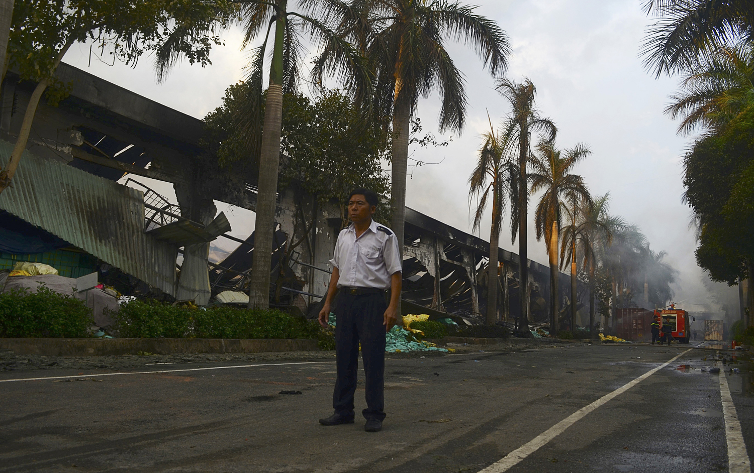 A security guard stands near a damaged Chinese owned shoe factory in Vietnam's southern Binh Duong province