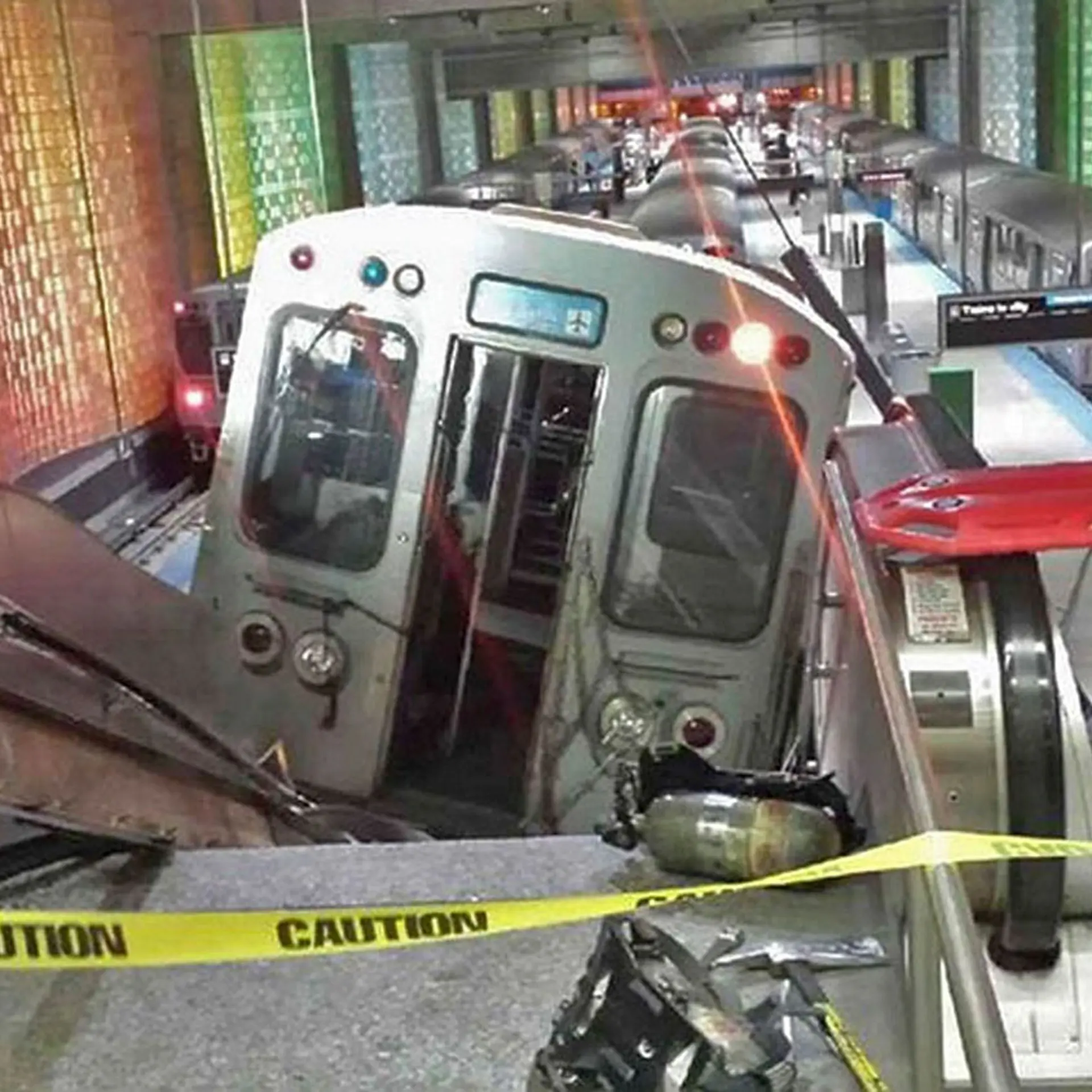 A handout photo shows a derailed commuter train resting on an escalator at O'Hare international airport in Chicago