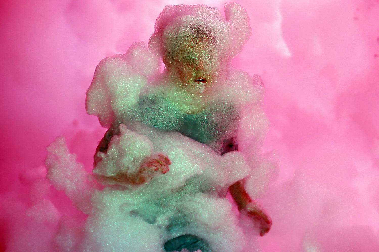 A competitor runs through a foam tunnel during the Brutal Run extreme obstacle course race in Budapest