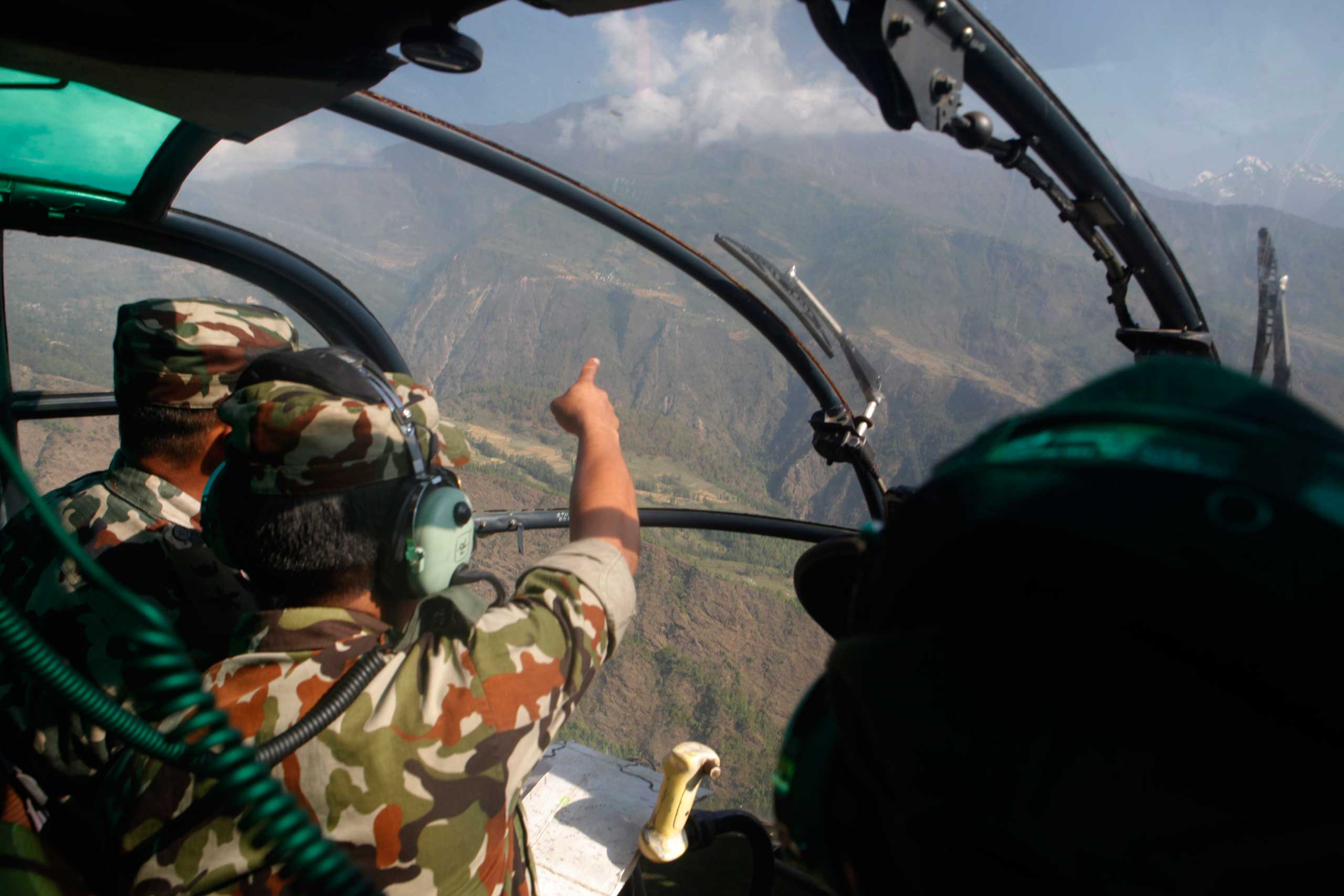 Nepalese army men search for the missing U.S. Marine helicopter in the earthquake affected Dolakha District of Nepal on May 14, 2015.