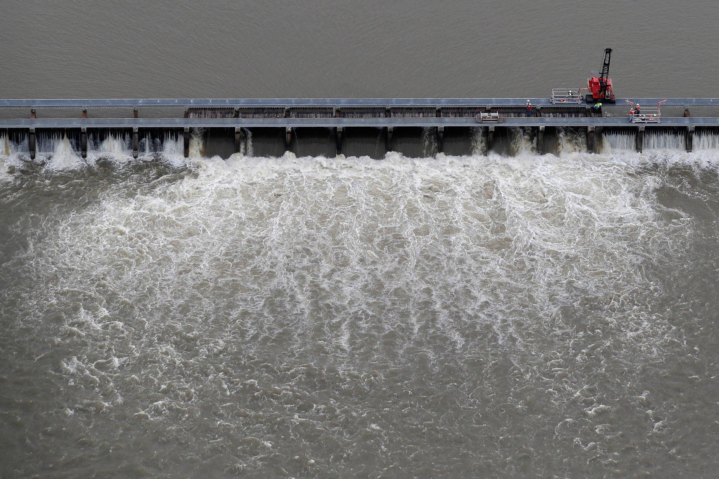 Workers open bays of the Bonnet Carre Spillway, to divert rising water from the Mississippi River to Lake Pontchartrain, upriver from New Orleans, in Norco, La., on May 10, 2019.