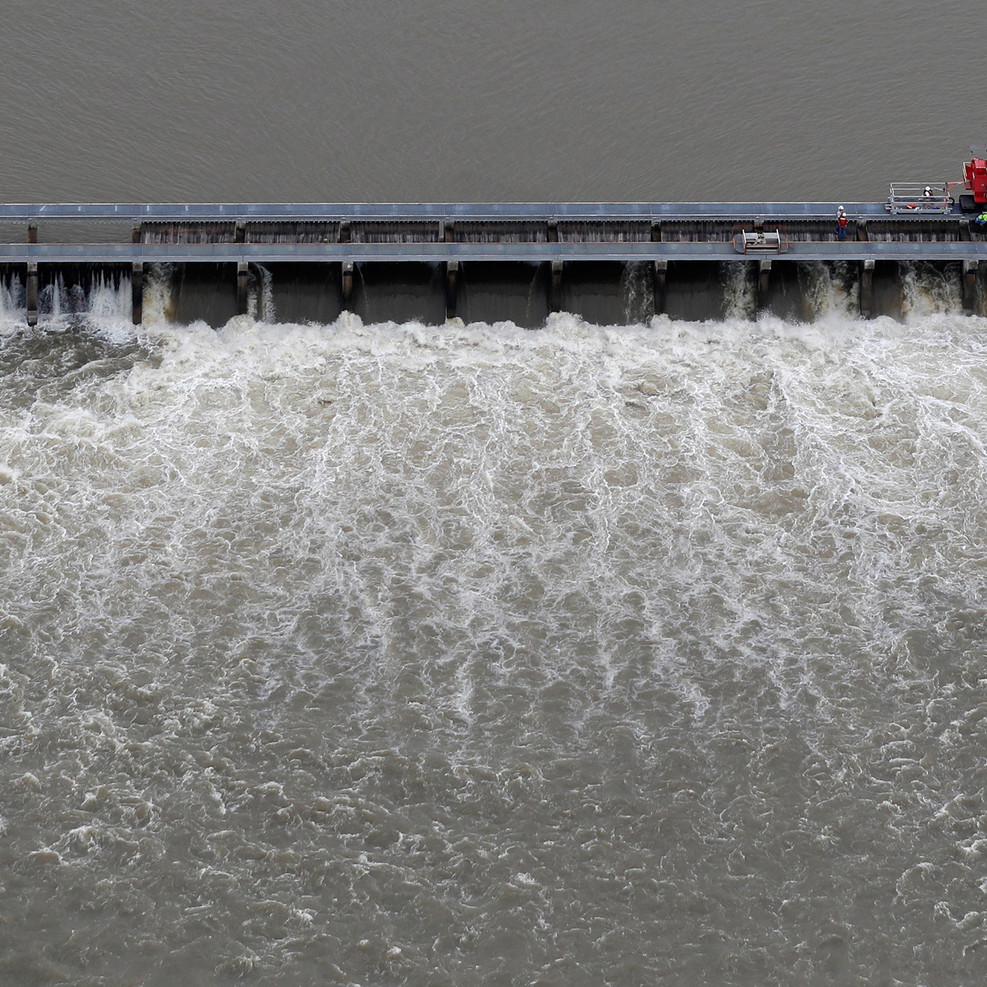 Workers open bays of the Bonnet Carre Spillway, to divert rising water from the Mississippi River to Lake Pontchartrain, upriver from New Orleans, in Norco, La., on May 10, 2019.