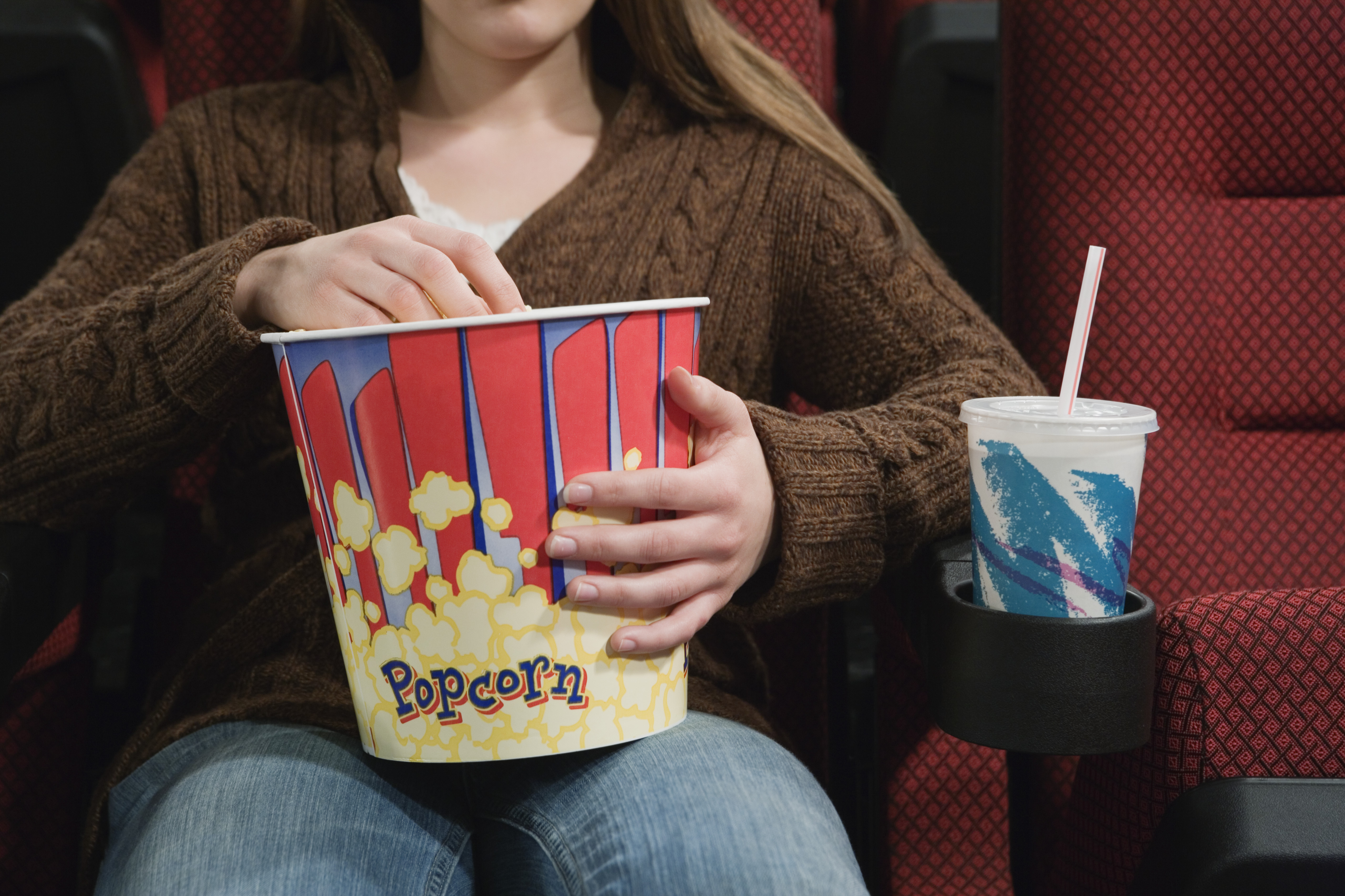 Girl in Movie Theater Eating Popcorn