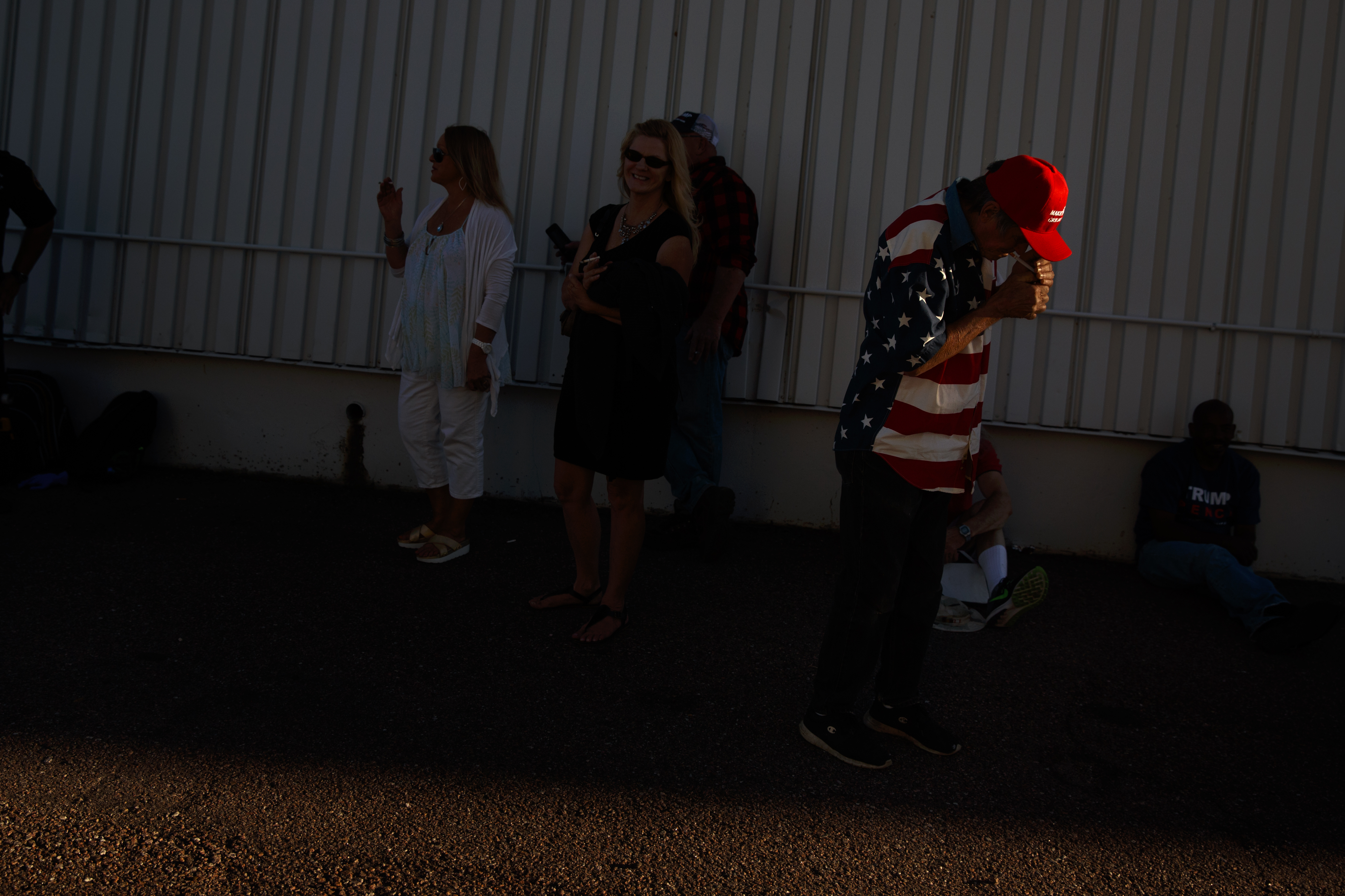 Robert Einspahr, of Denver, lights a cigarette as he waits for the arrival Republican presidential candidate Donald Trump to a campaign rally, Sept. 17, 2016, in Colorado Springs, Colo.