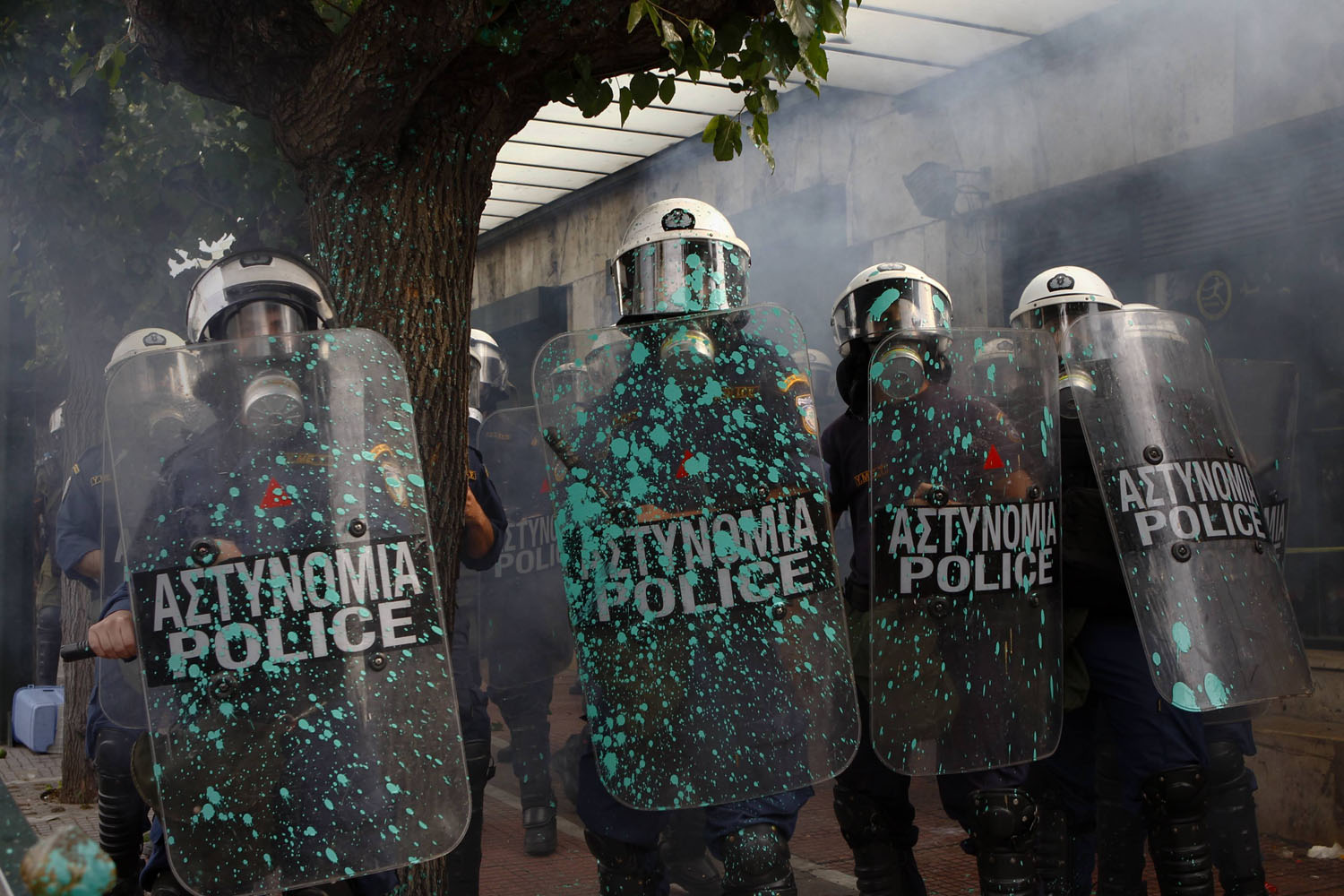 Oct. 9, 2012. Riot police stand guard outside the parliament in Athens during a violent protest against the visit of Germany's Chancellor Angela Merkel.