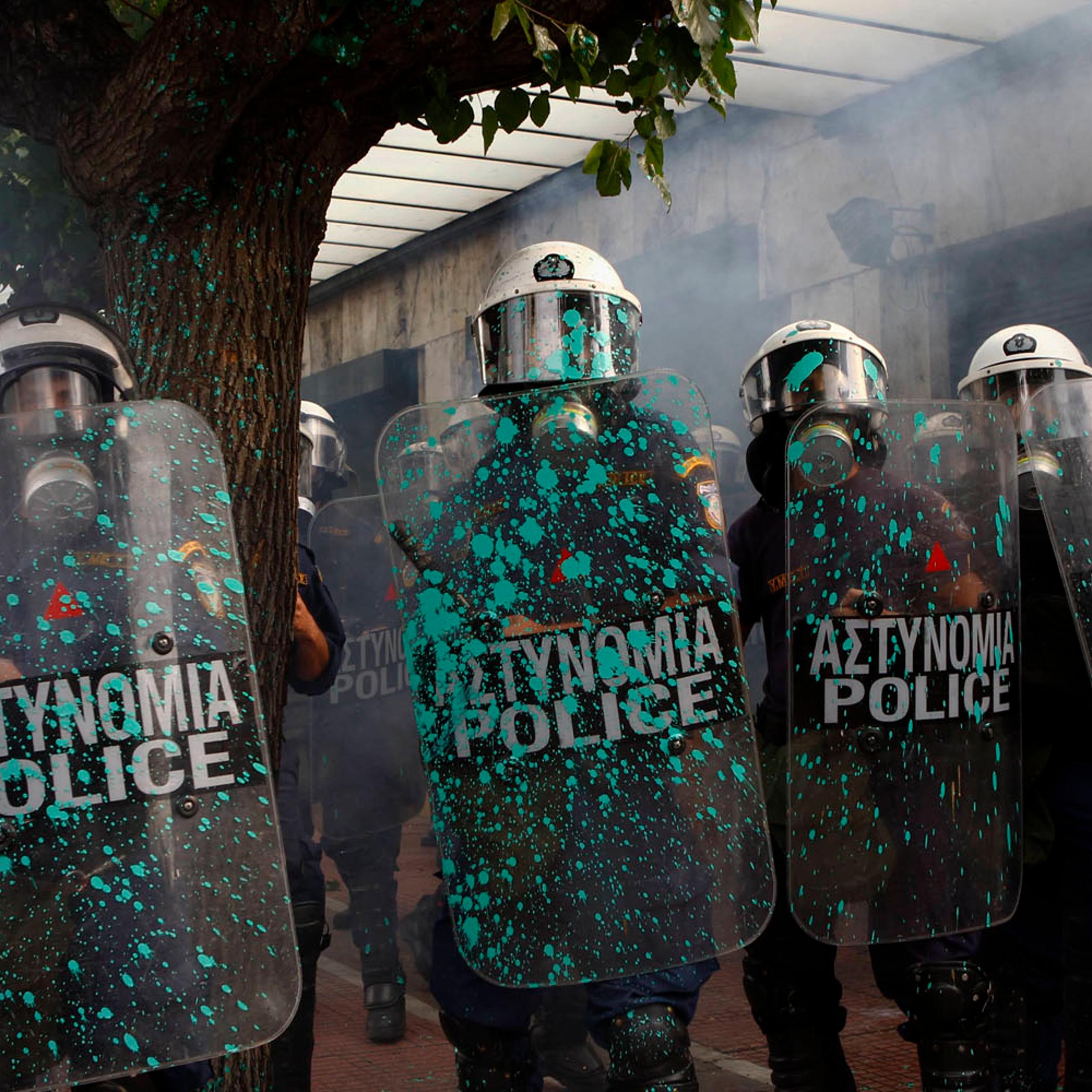 Oct. 9, 2012. Riot police stand guard outside the parliament in Athens during a violent protest against the visit of Germany's Chancellor Angela Merkel.