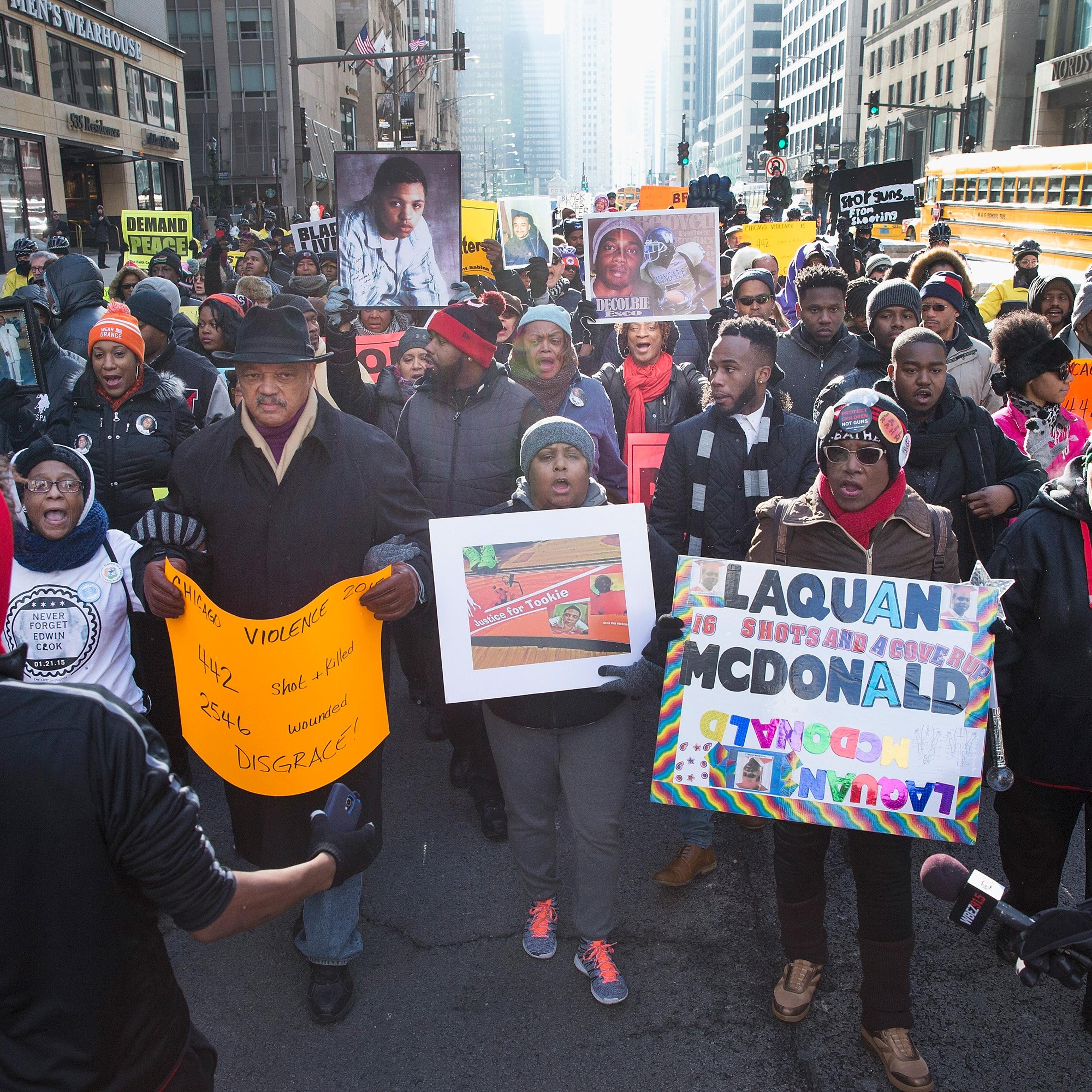 Rev. Jesse Jackson helps to lead demonstrators calling for an end to gun violence as they march through downtown Chicago on Dec. 31, 2015. The shooting deaths by police of a 19-year-old college student Quintonio LeGrier and his 55-year-old neighbor Betti