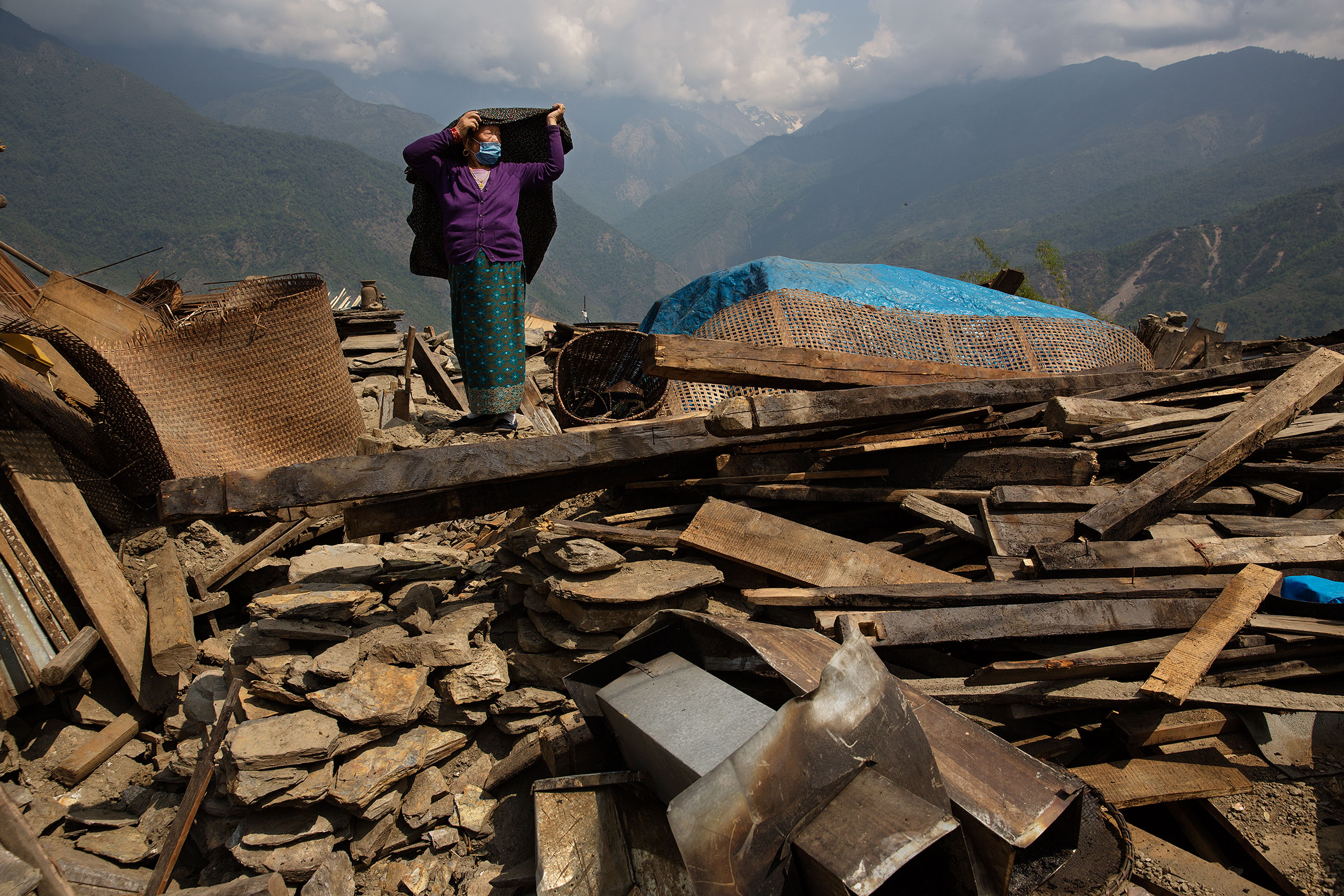 Nepal earthquake. Barpak, the epicenter of the earthquake. Funeral of Pur Bahadur Gurung, 26, who had just been dug out of the rubble. Saainli Gurung, his mother weeping. Scenes of villagers salvaging building materials and personal possessions. Dhan Raj