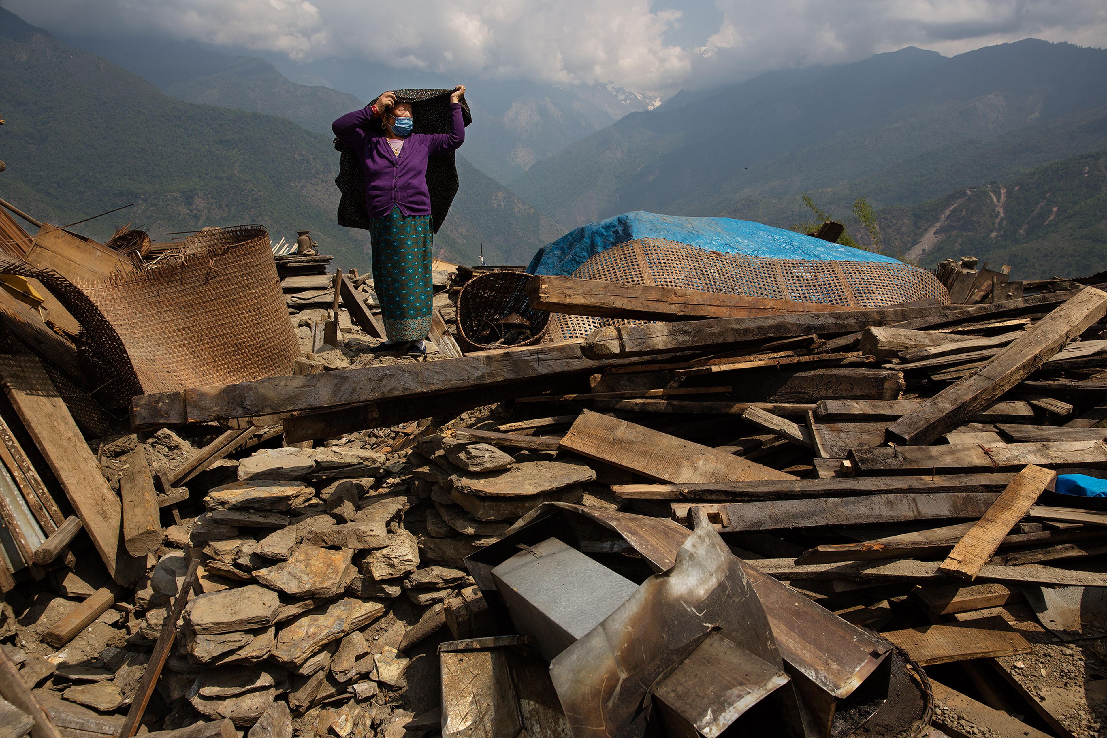 Nepal earthquake. Barpak, the epicenter of the earthquake. Funeral of Pur Bahadur Gurung, 26, who had just been dug out of the rubble. Saainli Gurung, his mother weeping. Scenes of villagers salvaging building materials and personal possessions. Dhan Raj