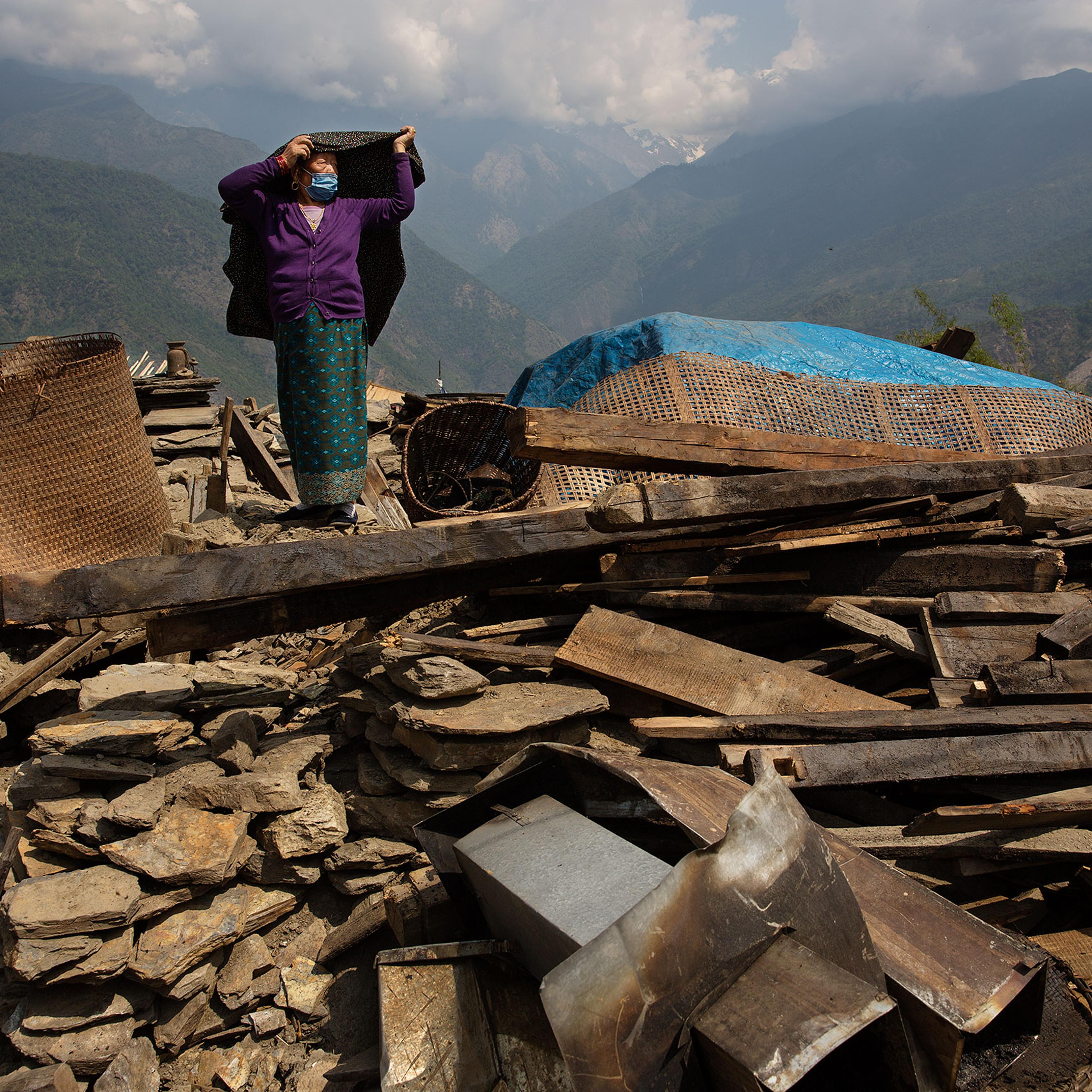 Nepal earthquake. Barpak, the epicenter of the earthquake. Funeral of Pur Bahadur Gurung, 26, who had just been dug out of the rubble. Saainli Gurung, his mother weeping. Scenes of villagers salvaging building materials and personal possessions. Dhan Raj