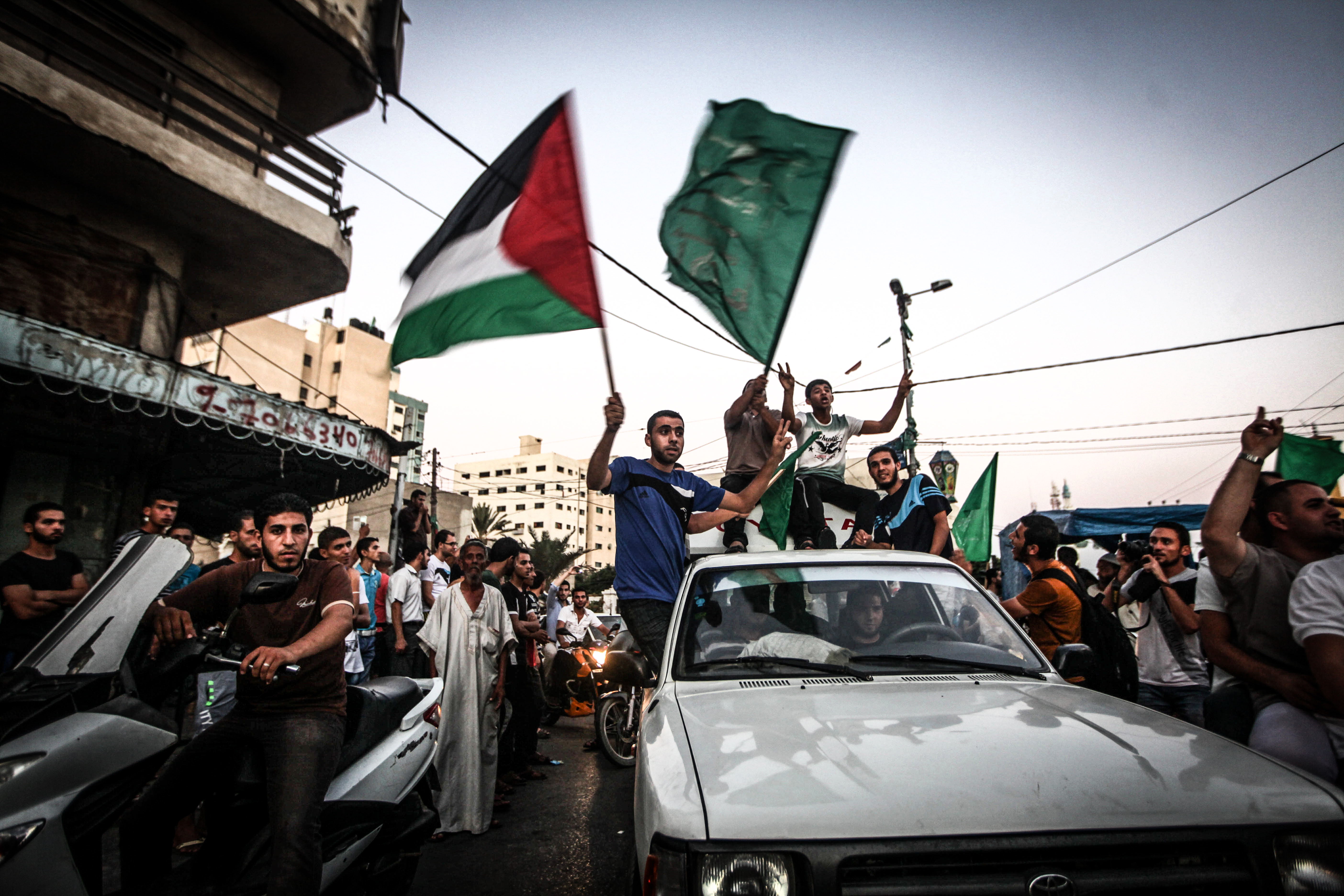 The sign of victory as people gather in the streets to celebrate after a deal had been reached between Hamas and Israel over a long-term end to seven weeks of fighting in the Gaza Strip on Aug. 26, 2014 in Gaza City.