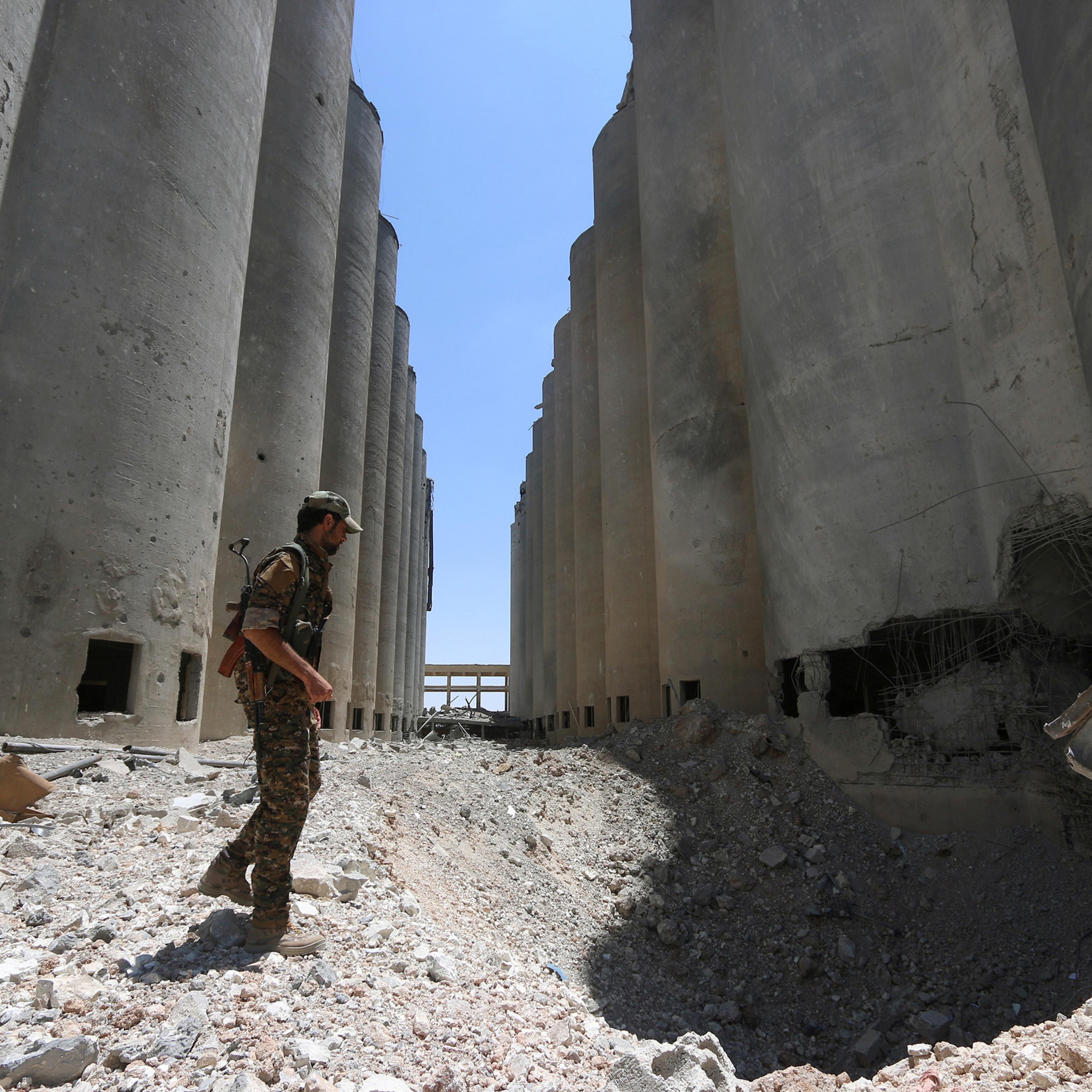 A Syria Democratic Forces (SDF) fighter walks in the silos and mills of Manbij after the SDF took control of it, in Aleppo Governorate, Syria on July 1, 2016.
