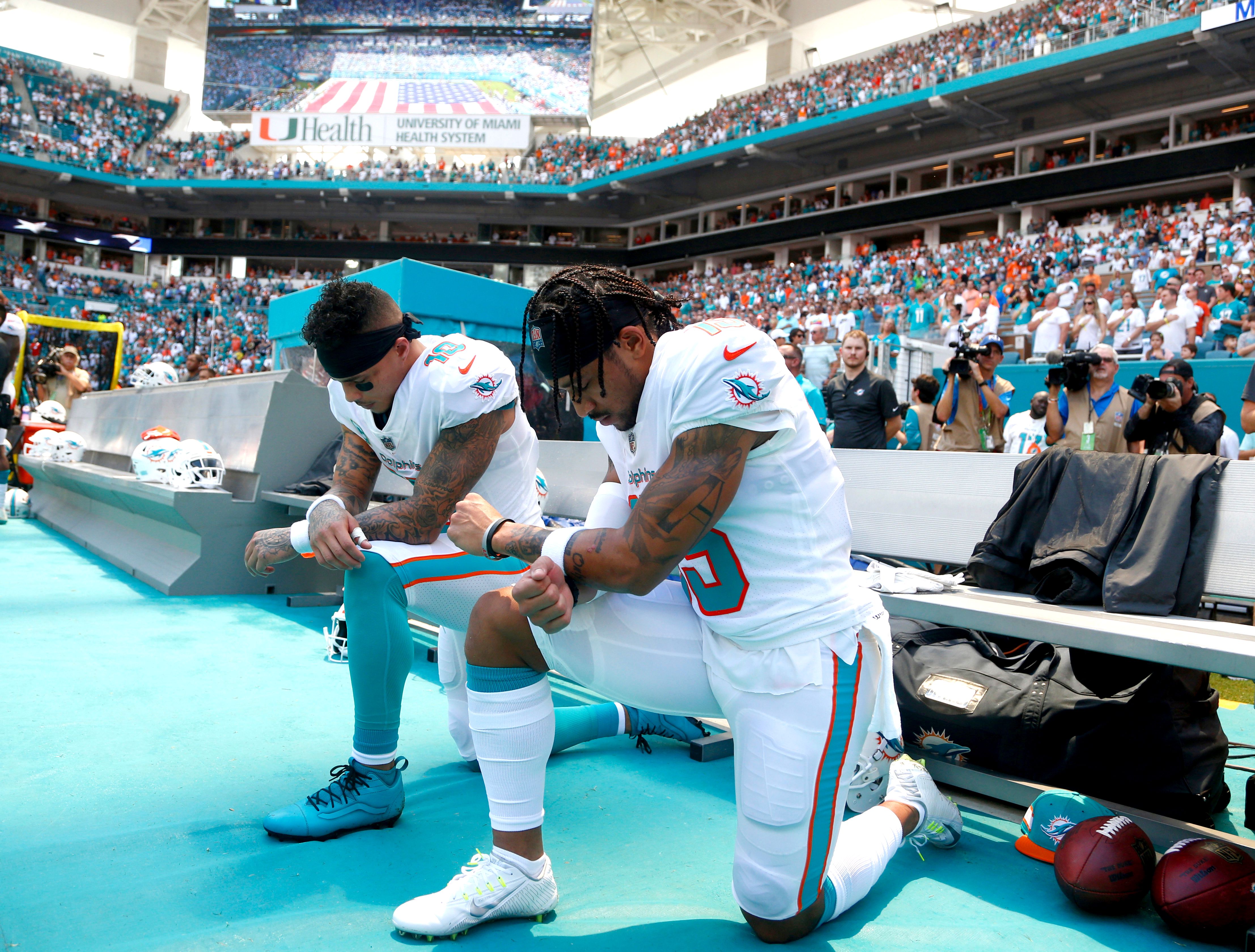 Football players kneeling during the National Anthem