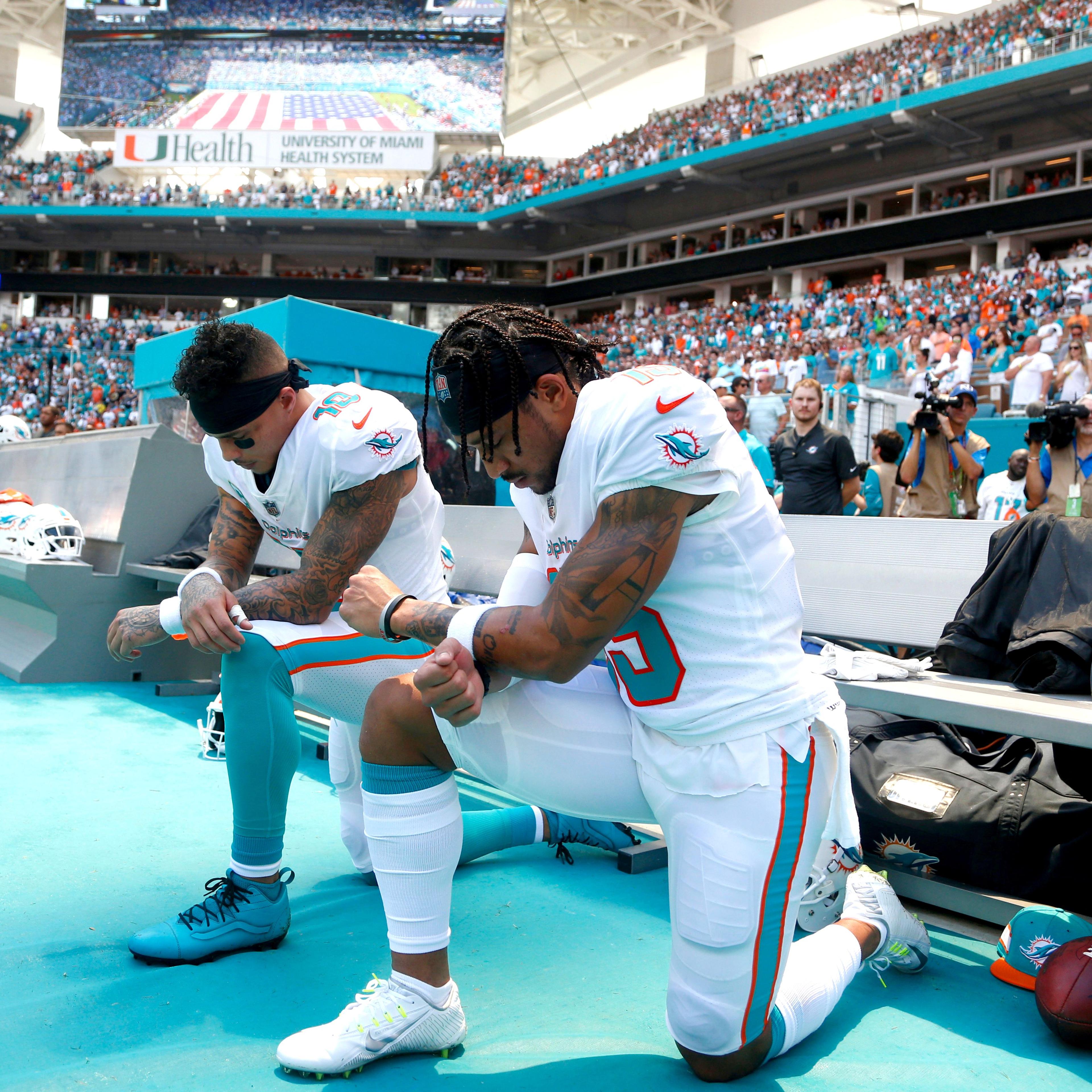 Football players kneeling during the National Anthem