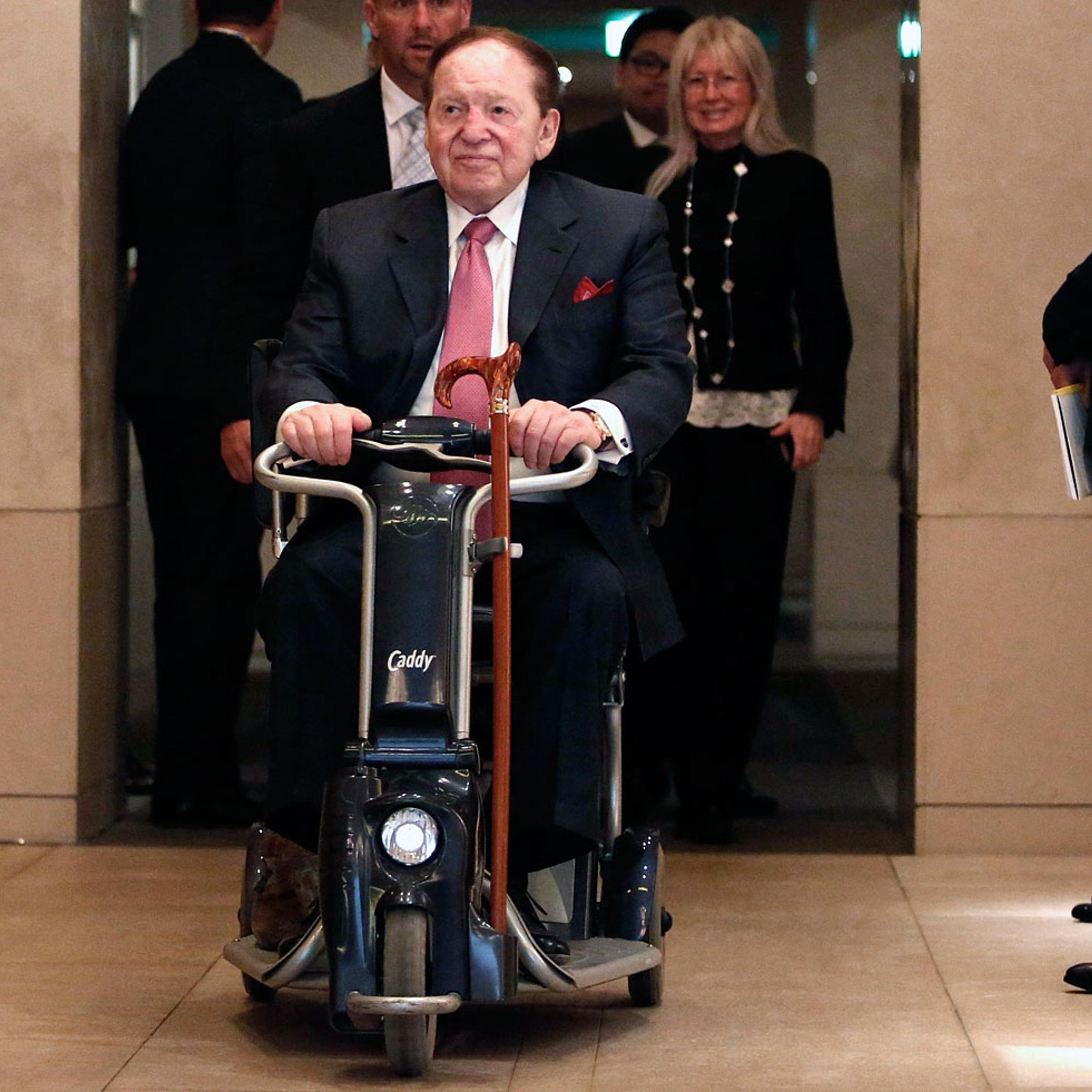 Las Vegas Sands Corp Chairman and Chief Executive Officer Sheldon Adelson rides his wheelchair after a news conference in Tokyo , Feb. 24, 2014