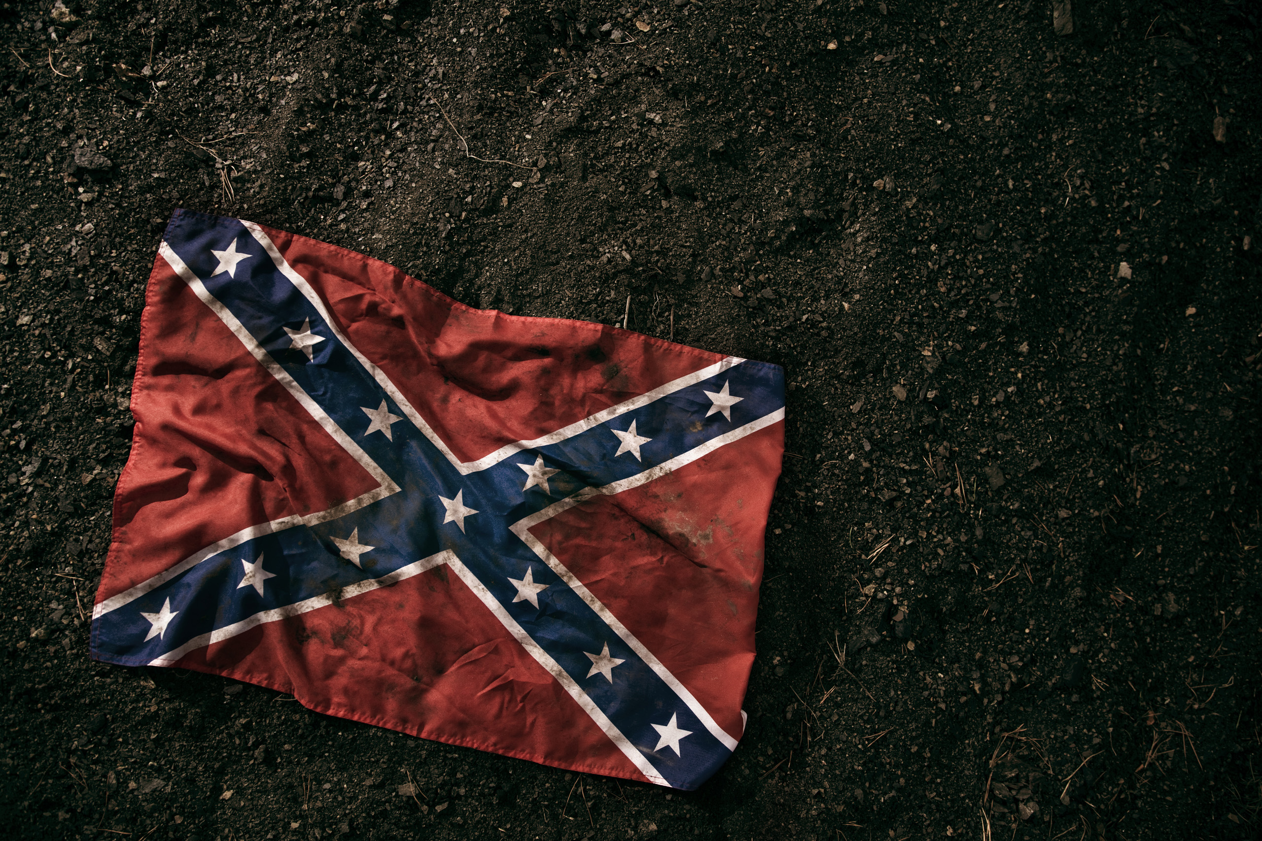 Low key photography of grungy old Confederate Battle Flag.