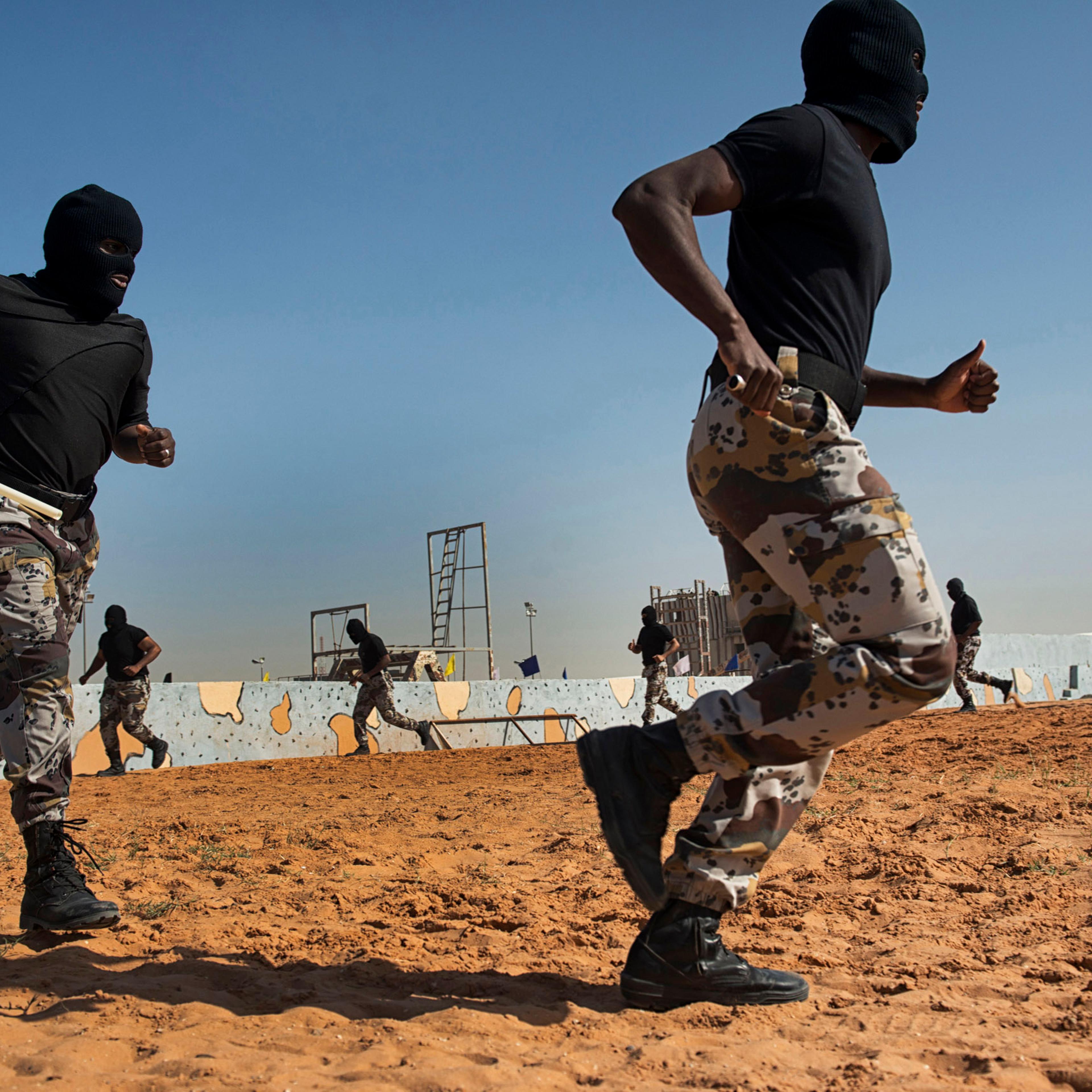 Troops with the Saudi Special Security Forces warm up and perform basic exercizes to increase strength and agility at the Counter-Terrorism Training School camp under the Ministry of Interior in Riyadh, Saudi Arabia, March 5, 2013. The Saudi government