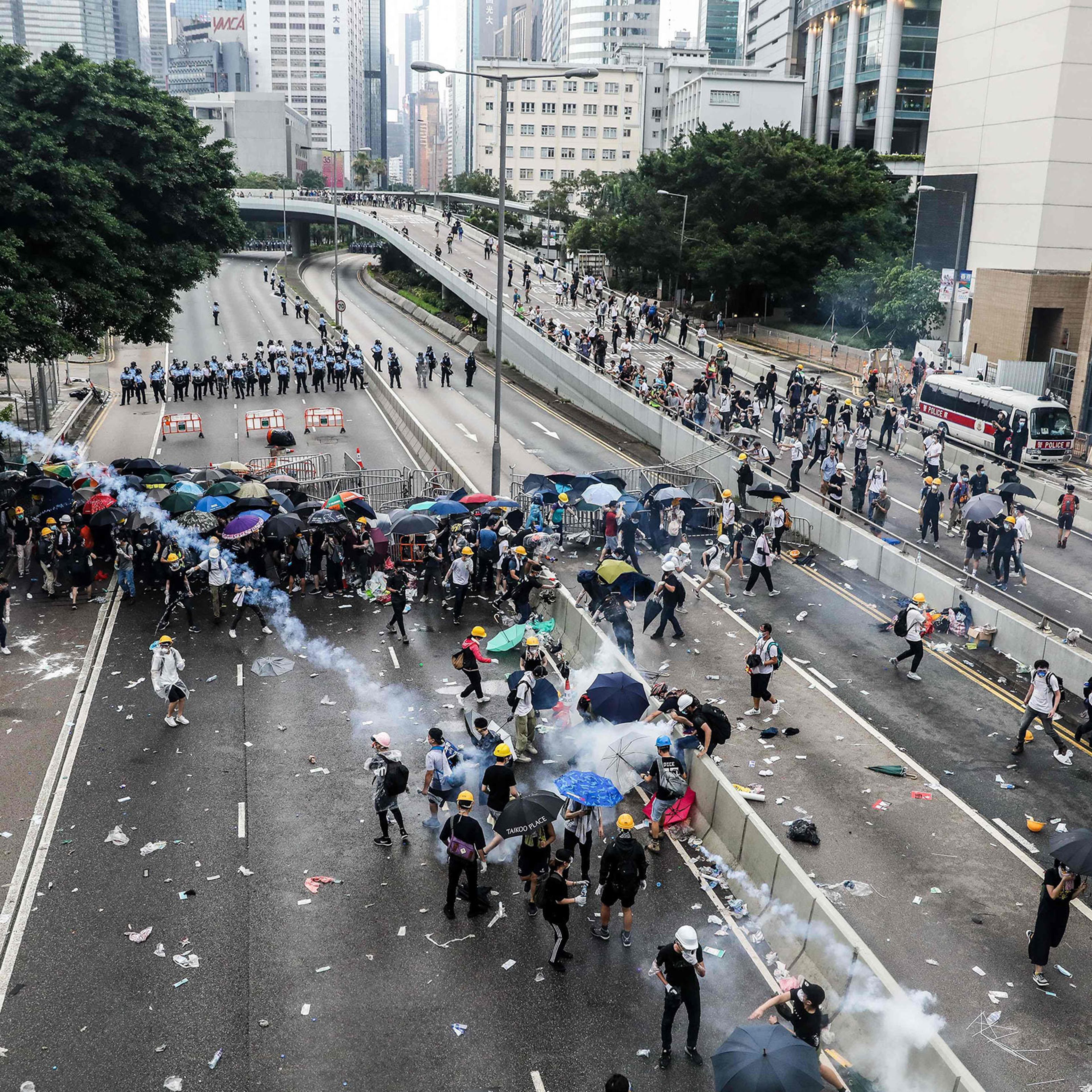 Protesters throw back a tear gas canister fired by police during a rally against an extradition law proposal outside the government headquarters in Hong Kong on June 12.