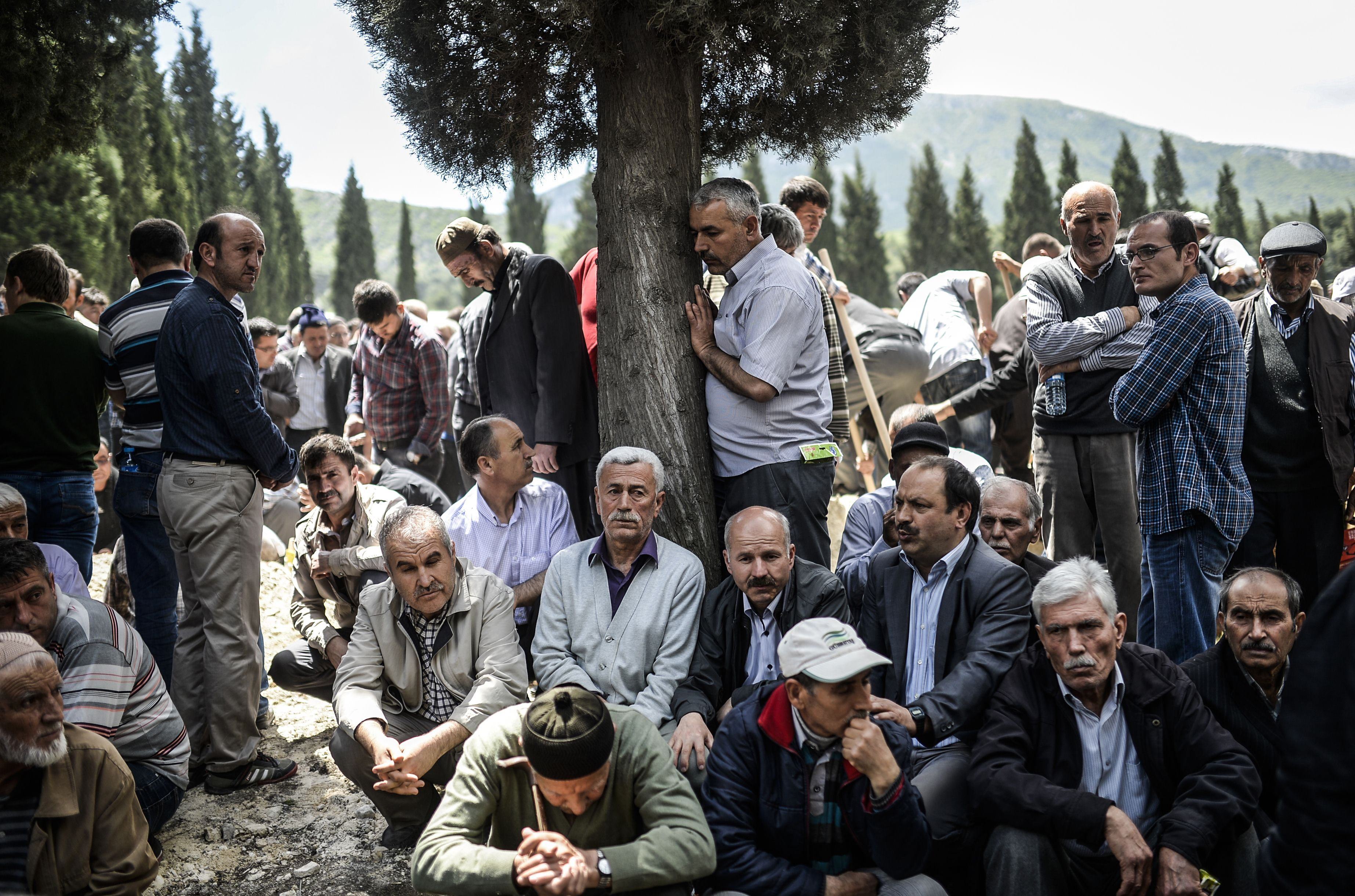 People mourn in a cemetery during the funeral ceremony of miners who died in an explosion on May 15, 2014, in the western town of Soma in the Manisa province.