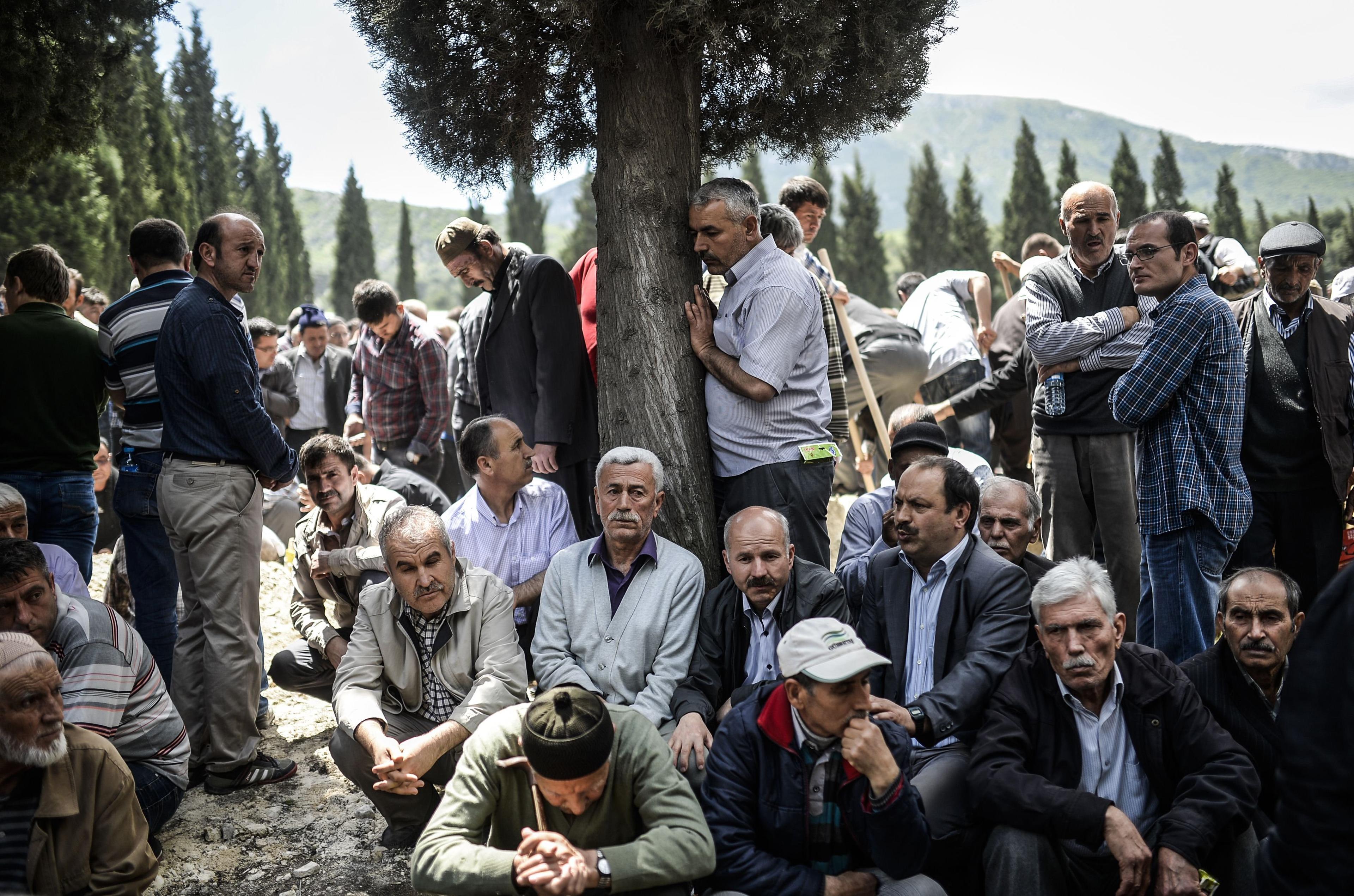 People mourn in a cemetery during the funeral ceremony of miners who died in an explosion on May 15, 2014, in the western town of Soma in the Manisa province.