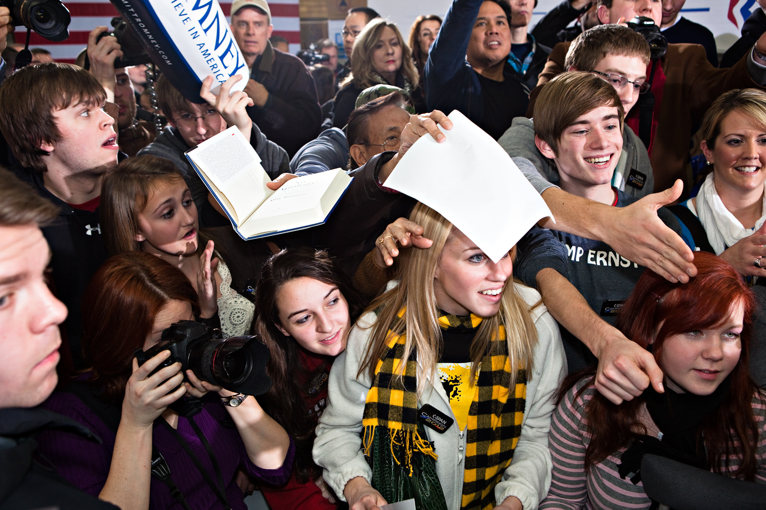 Young Romney supporters swarm to meet him for autographs at a campaign stop in Clive, Iowa on January 2, 2012.