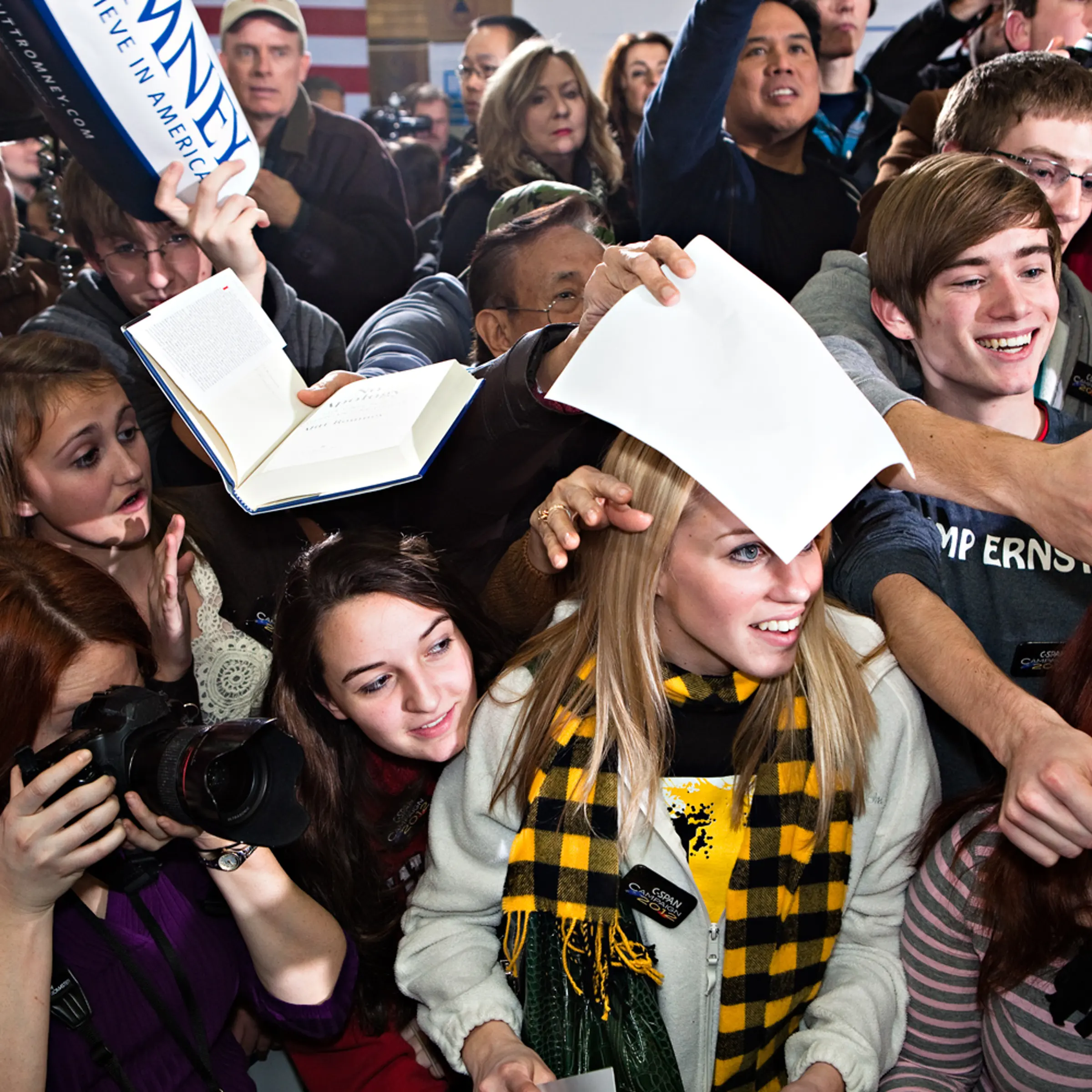 Young Romney supporters swarm to meet him for autographs at a campaign stop in Clive, Iowa on January 2, 2012.